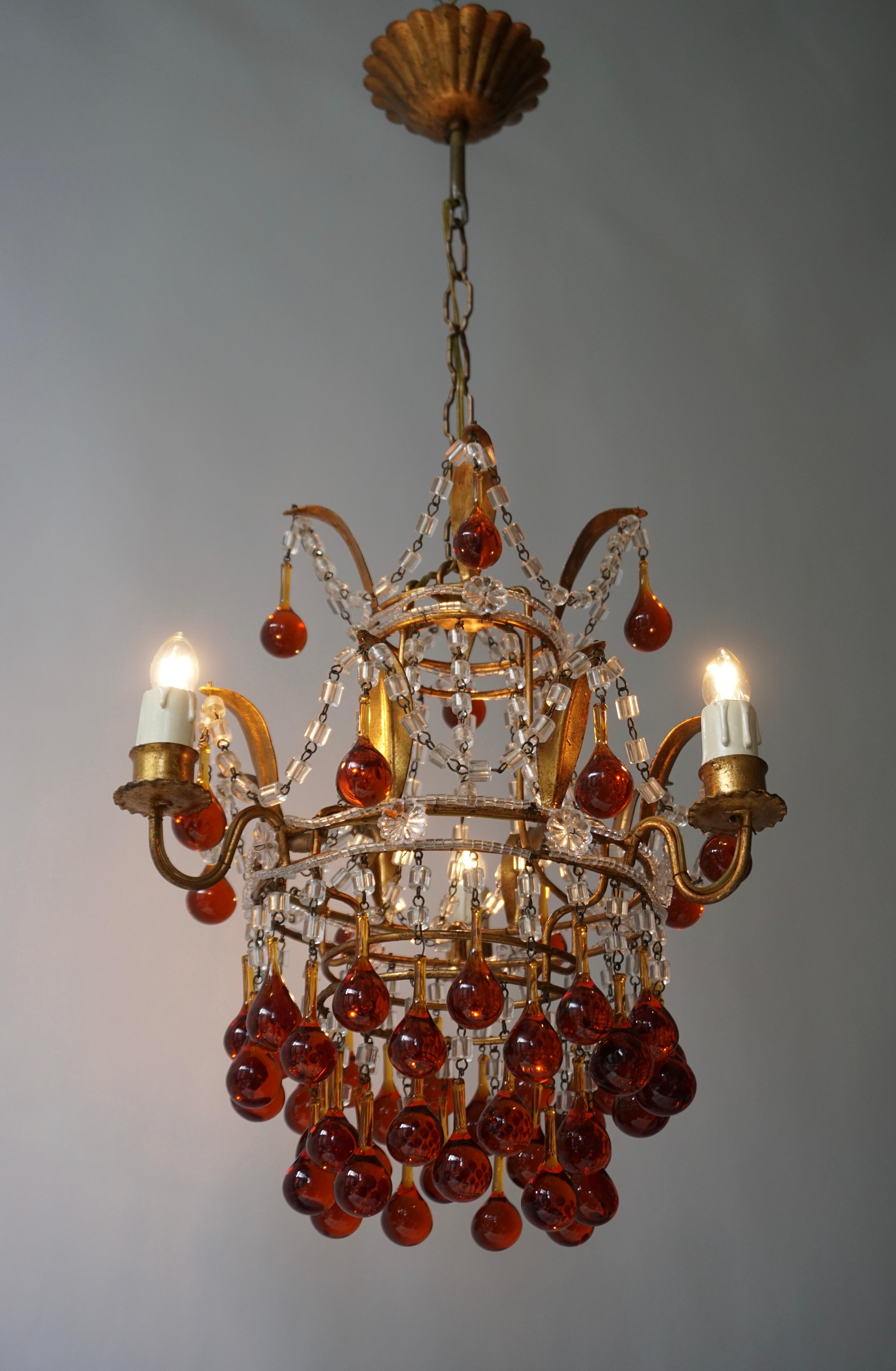 A lovely vintage Venini style chandelier three-light with Murano amber glass teardrops, brass mounts, Italy, 1950s. 

Brass with some wear and agd patina. 

Three E-14 light bulb sockets. 

Dimensions: Total height with chain 72 cm, adjustable