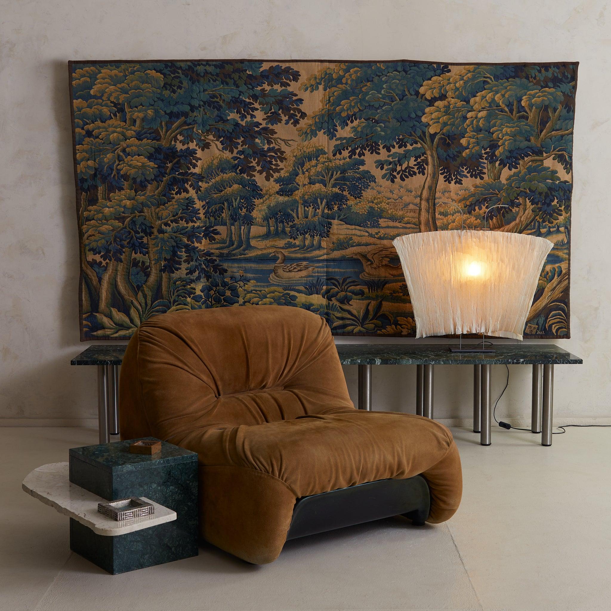 A composition of elemental form, this 1970s Italian side table reads as sculpture first, function second. Anchoring the design is a monolithic cube of Verde Alpi marble, its deep green surface flecked with serpentine veining. From its center, a