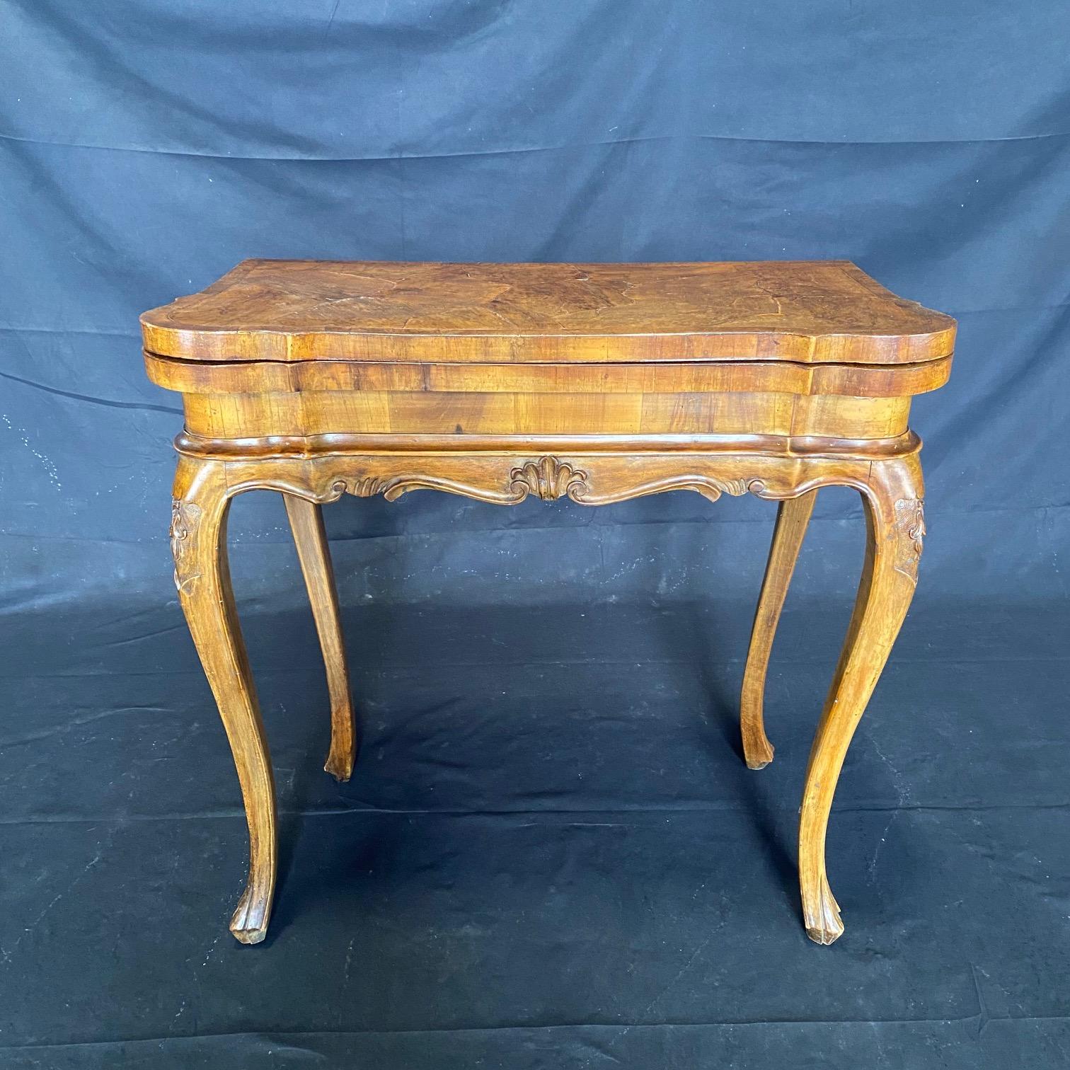 Italian 18th century burled walnut game or card table, side table or console, circa 1780. This very elegant table is made of walnut and its top is beautifully joined burled walnut. The table skirt and legs are highly carved Louis XV walnut, with