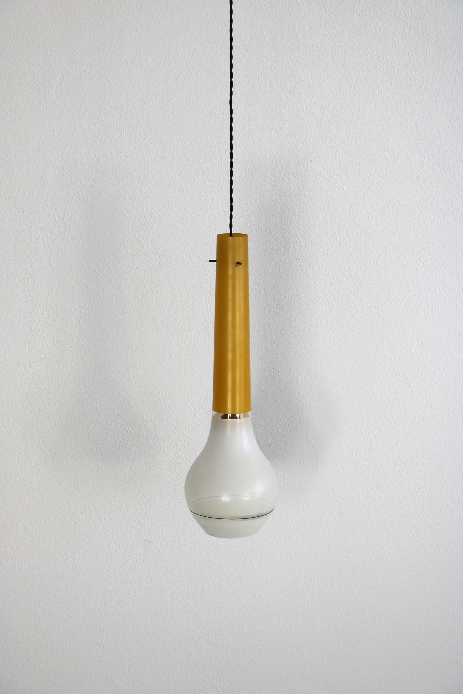 This Italian pendant comes from the 1960s. This Italian pendant comes from the 1960s. While the upper part of the lamp is made of yellow, elongated shaped glass, the lower part of the lamp is made of matt, white glass round shaped. It has a newly