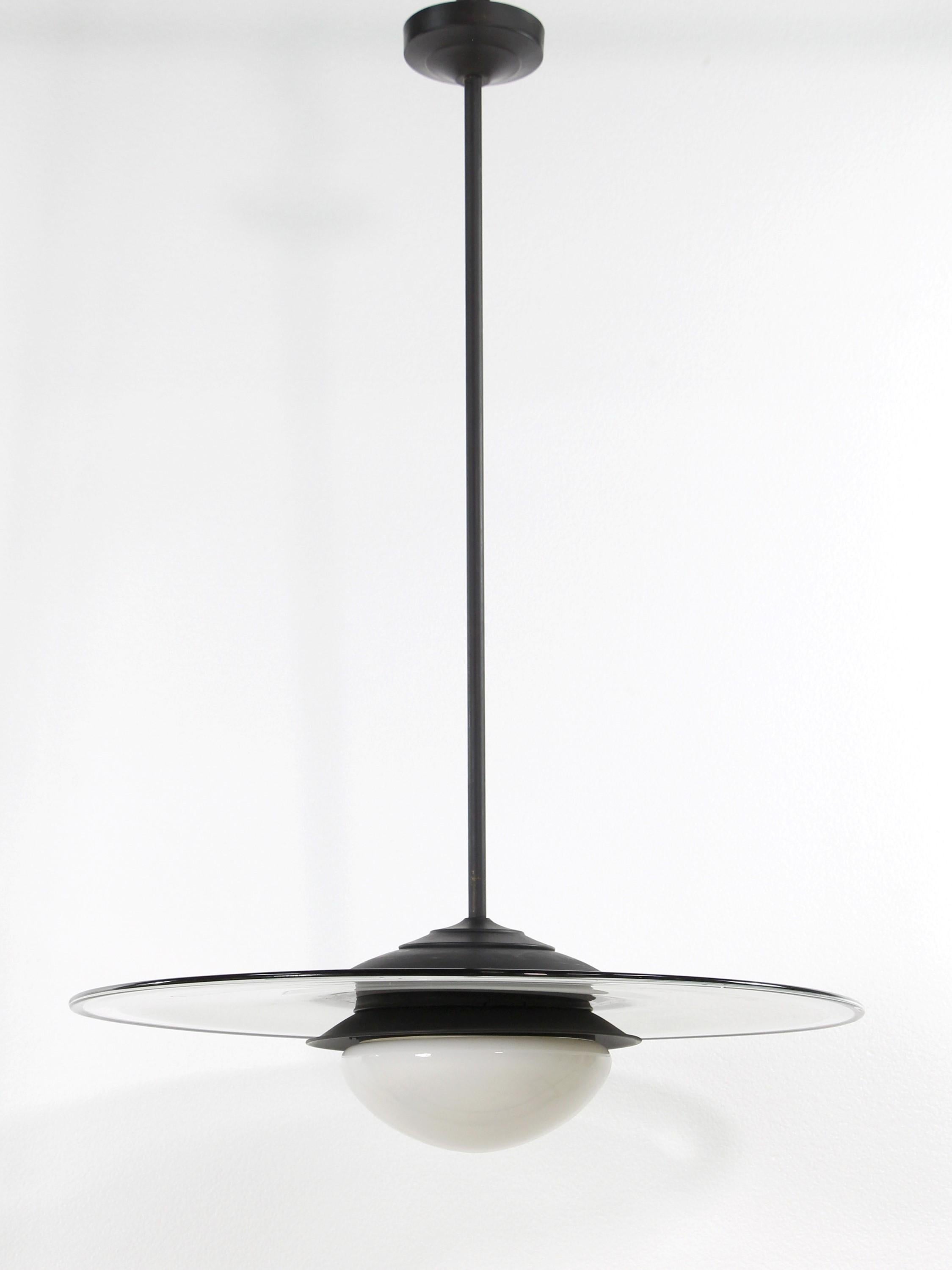 Vetri Murano Italian pendant light with white pancake shape glass with outer clear glass and a black rim.  Underneath is a white glass globe.  The hardware is newly wired and features a darkened long pole.  The price includes cleaning and wiring.