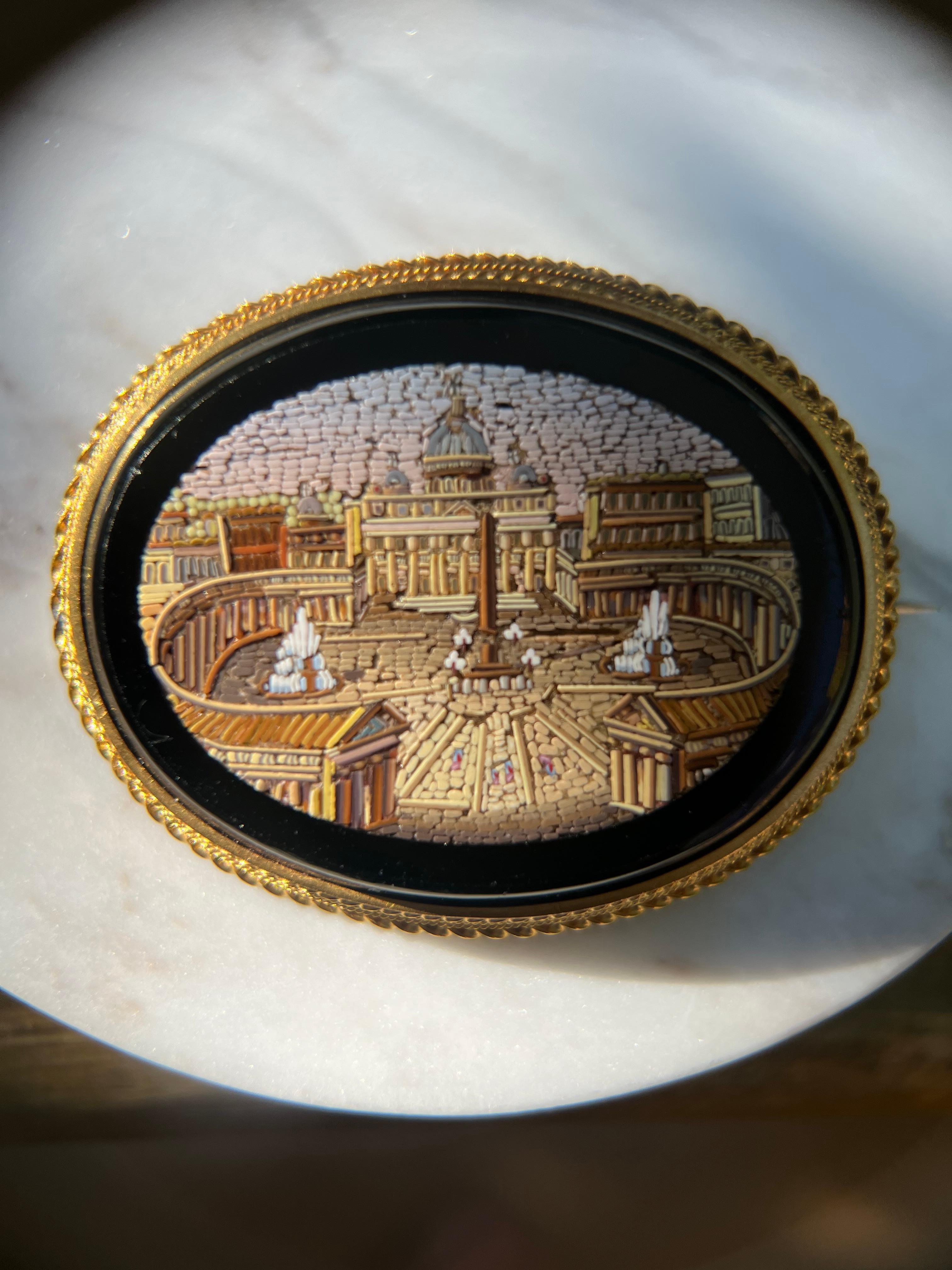 One 14 karat yellow gold micro mosaic brooch depicting St. Peter's Square in Italy.  The brooch measures 1.75 inches and is complete with a traditional pin closure.  