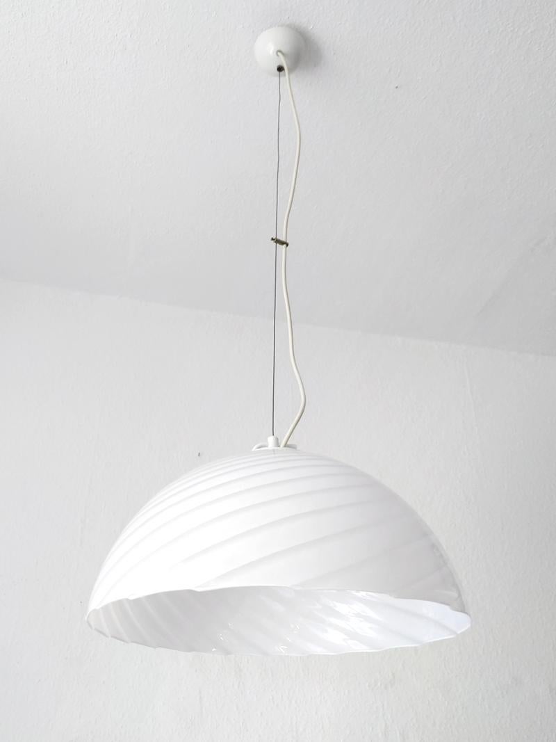Beautiful white hand blown Murano glass pendant light.
Italy, 1970s.
Measures: Diameter (glass) 16.5 in
Height (glass) 8.2 in
Lamp sockets: one x E27 (US E26).
       