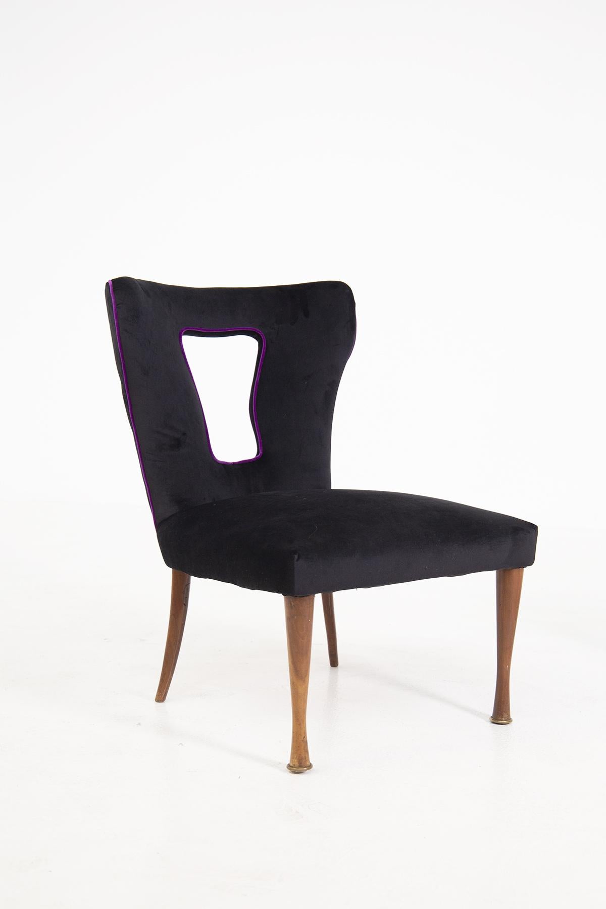 Beautiful pair of Italian armchairs from the 1950's. The pair of armchairs have been recently restored in a soft and glamorous black velvet fabric.
The feature that makes this pair very glamorous is its purple velvet border that creates a strong