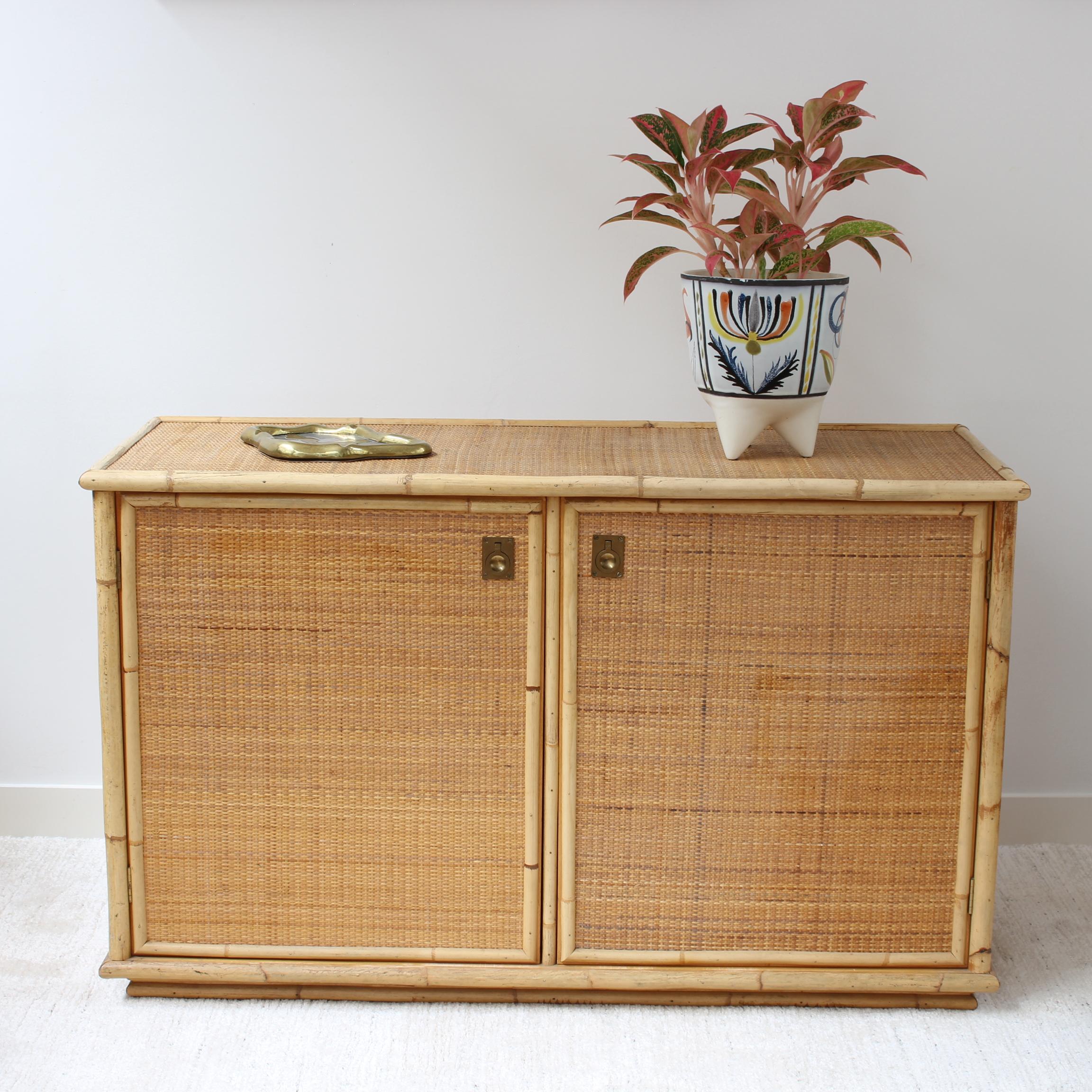 Bamboo and wicker credenza from Italian maker, Dal Vera (circa 1970s). Delightful piece with four spacious compartments behind two cupboard doors with smart brass fittings. San Remo, Monte Carlo, Nice and Cannes come to mind as this distinctive