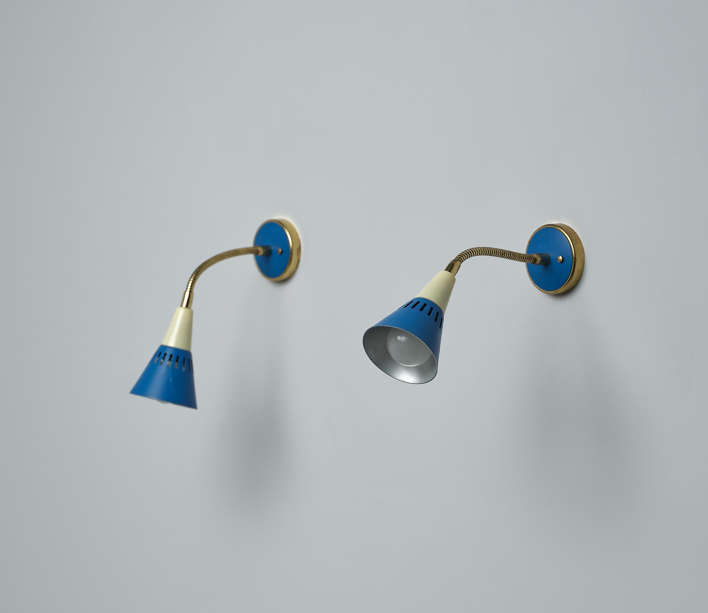 Presenting a  delightful pair of Italian-designed Appliques from the 1950s. Crafted with a blend of sophistication and whimsy, these appliques feature a charming combination of cream and blue lacquered metal, exuding retro elegance. The adjustable