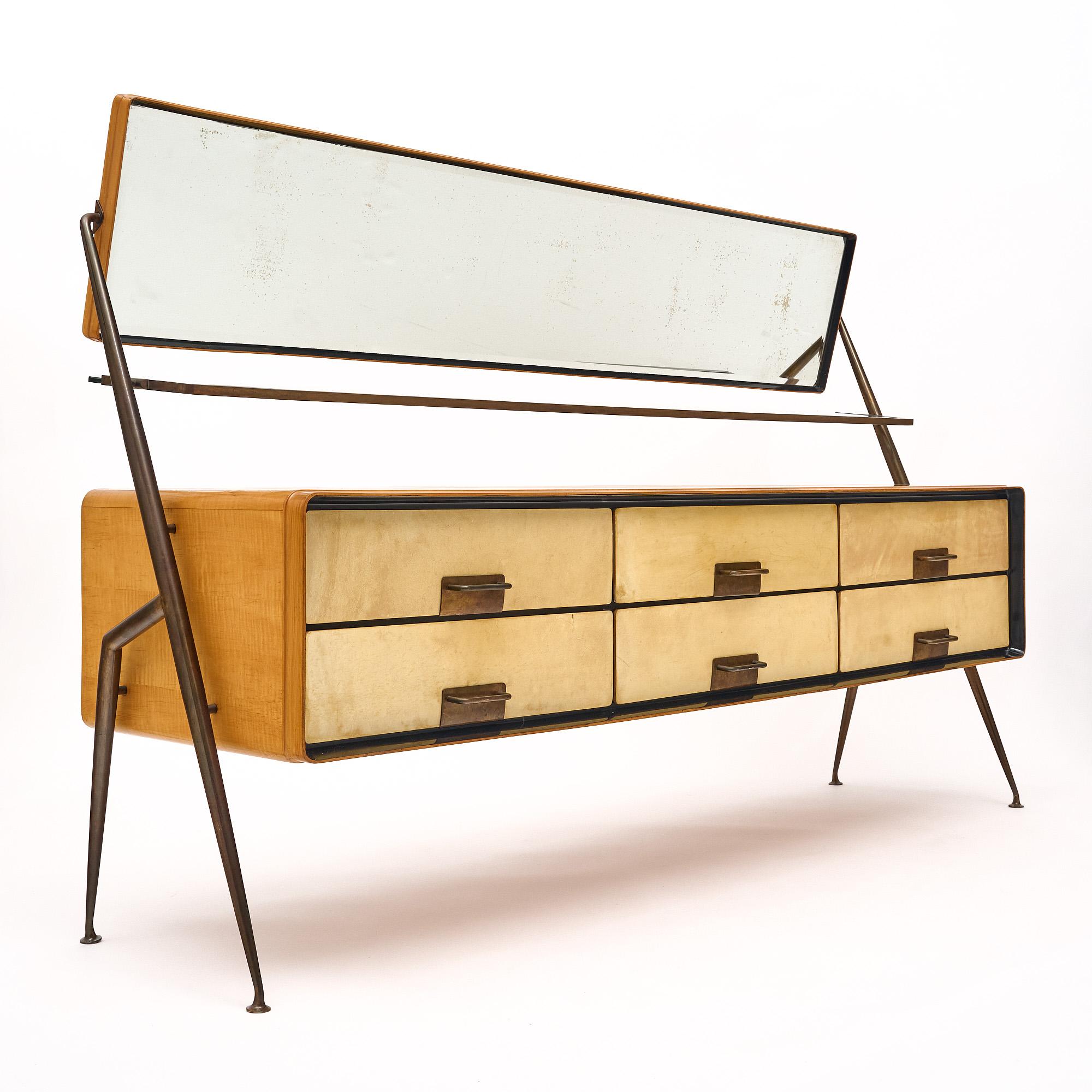 Chest of drawers/vanity, from Italy, by Silvio Cavatorta. This piece is made of maple with six dovetailed drawers. This sophisticated cabinet features a reclining beveled mirror and a beveled glass shelf. the structure holding the main body of the