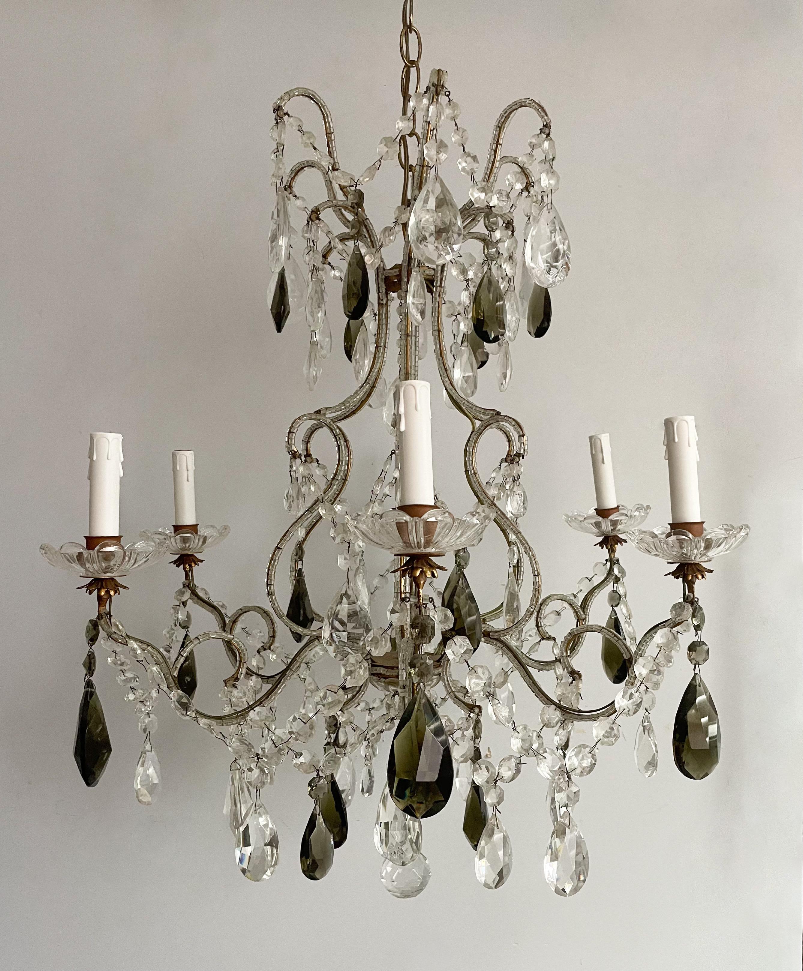 Beautiful, Italian 1940s crystal beaded chandelier with a gilt- iron frame and crystal decorations including faceted, dark green hued glass prisms.

The chandelier is wired and in working condition, it requires 6  candelabra bulbs. A ceiling canopy