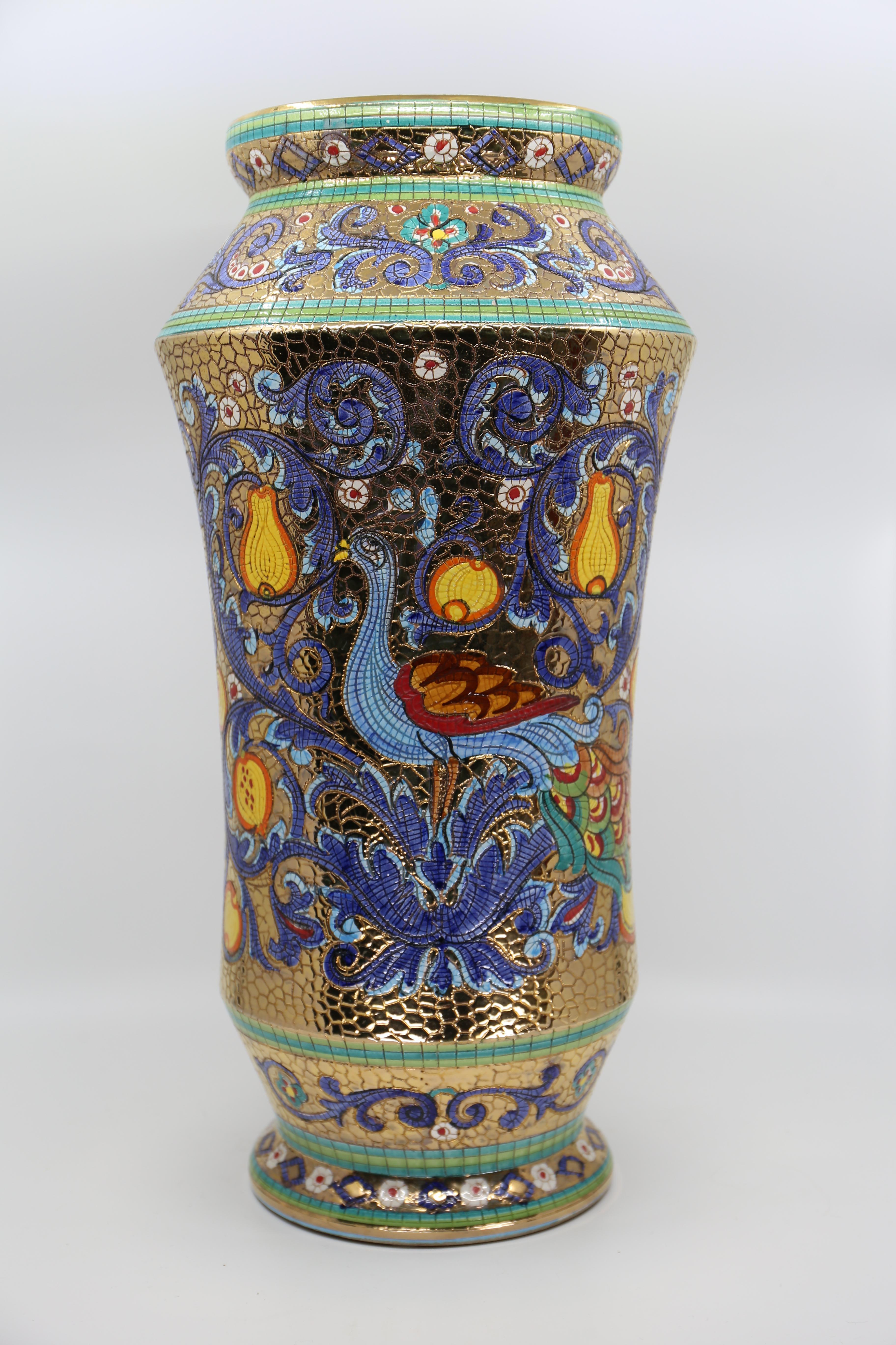 Large Majolica mosaic vase, hand decorated with pure gold leaf.

Italian Vintage Deruta Mosaic Vase, design is a depiction of Empress Theodora, sixth century Byzantine wife of Emperor Justinian, later canonized by the Eastern Orthodox Church as