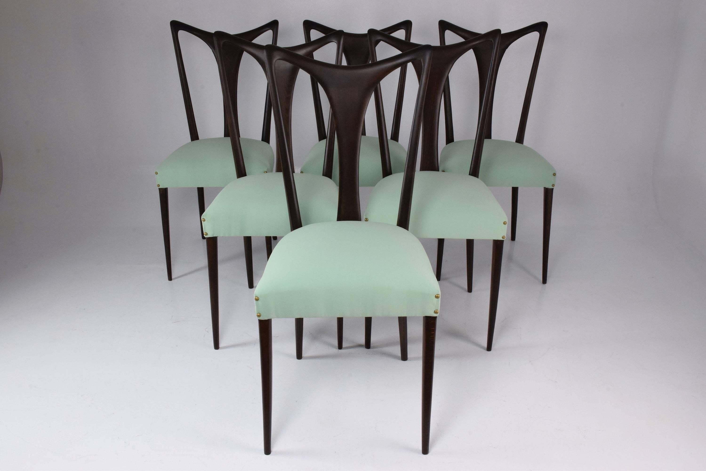 Set of six 20th century vintage Italian dining chairs designed by Guglielmo Ulrich, circa 1940s in fully restored condition composed of ebonized wood and re-upholstered with new nailhead trim in a beautiful Lelièvre Paris green mint fabric, 
Italy,