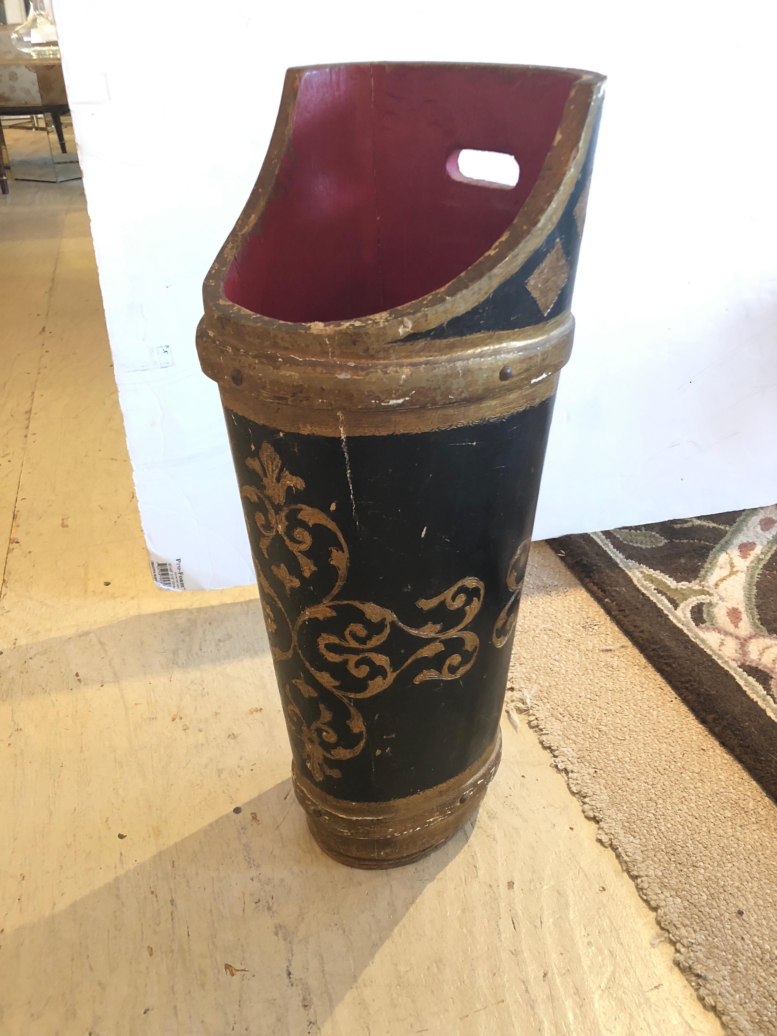 Vintage Italian Florentine umbrella stand in rich gilded gold, black and bright red interior. It is thick wood, weighted and heavy in order to hold umbrellas or place as a decorative accessory.
