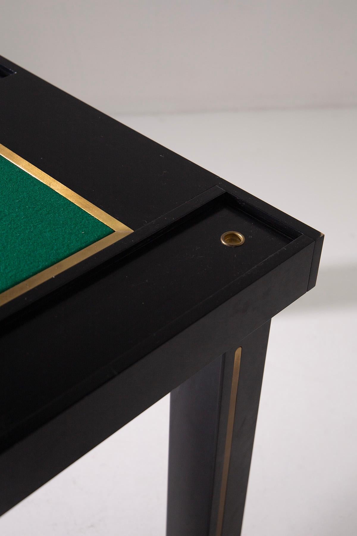 This rare 1970s game table is a true celebration of elegance and the craftsmanship of Italian design. Made from fine ebonized wood and enriched with brass details that create a refined contrast, this table stands out for its understated yet