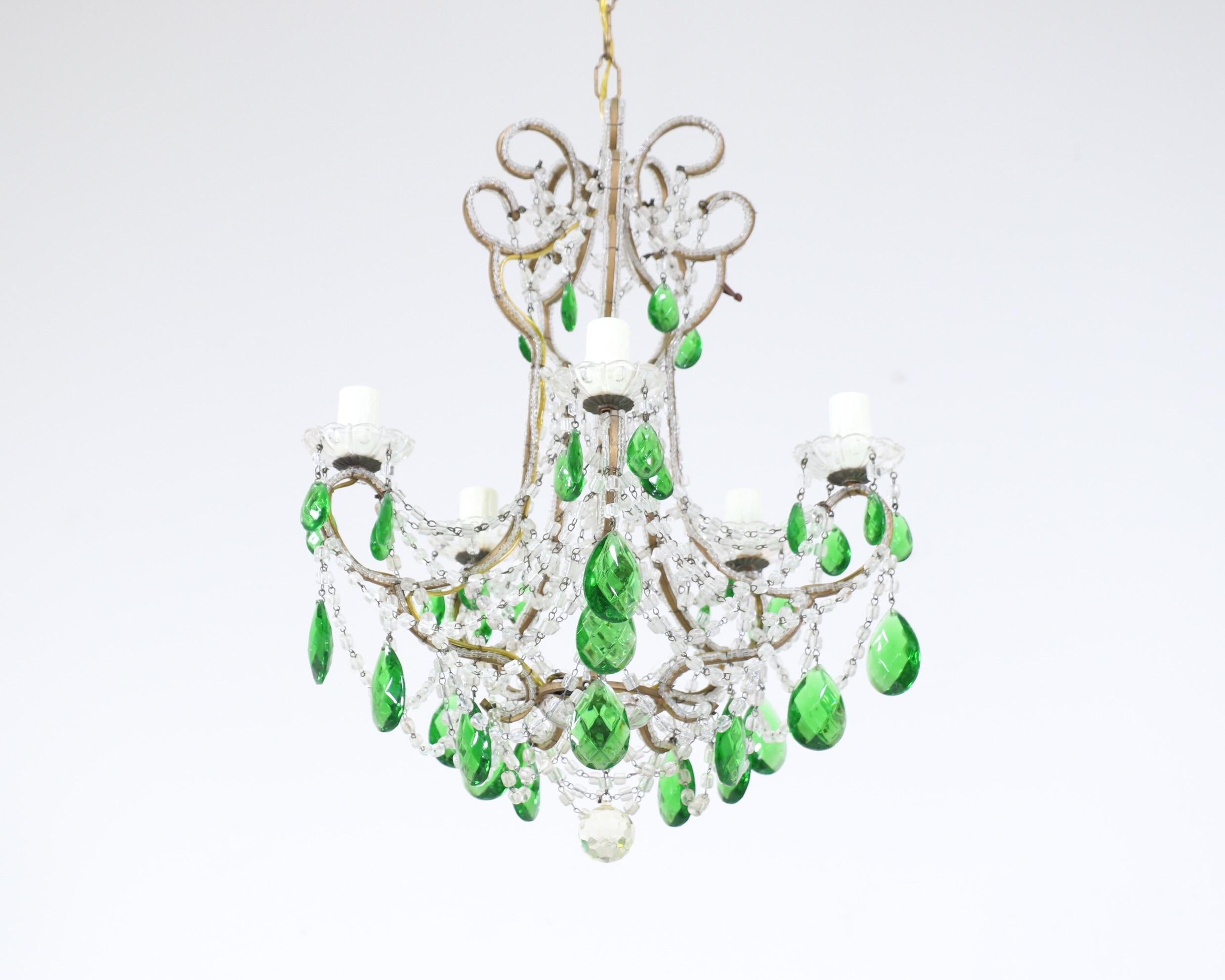 Very pretty, 1950s Italian gilt-iron and crystal beaded chandelier.

The chandelier consists of a shapely gilt-iron frame with loads of macaroni glass beads and green faceted prisms in an assortment of sizes. The chandelier is wired and in working