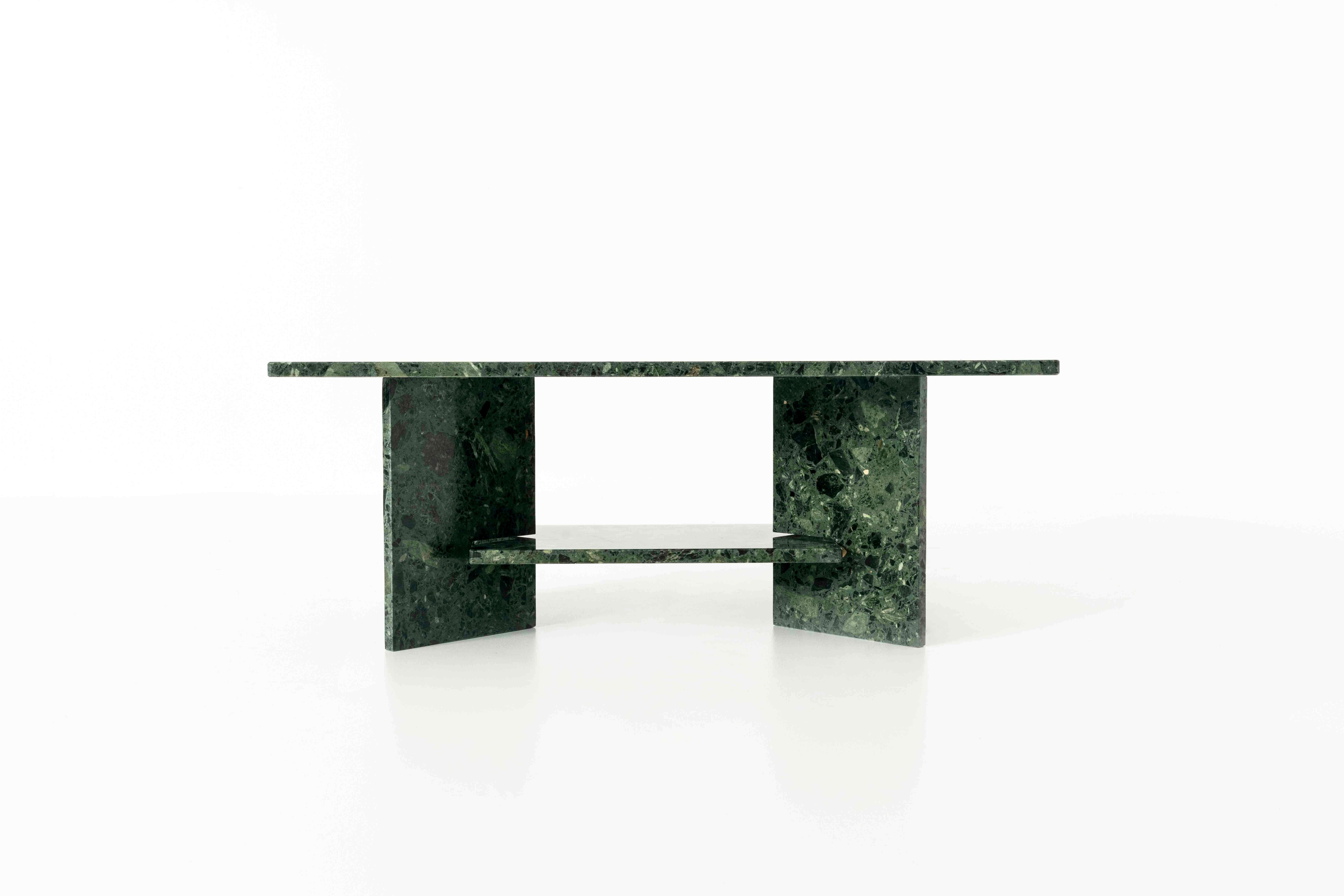 Stunning green marble coffee table. The table consists of four elements that can be fitted together. The two triangular legs hold the lower table top and the full tabletop is put on top of the table. The design is clean and the marble has an amazing