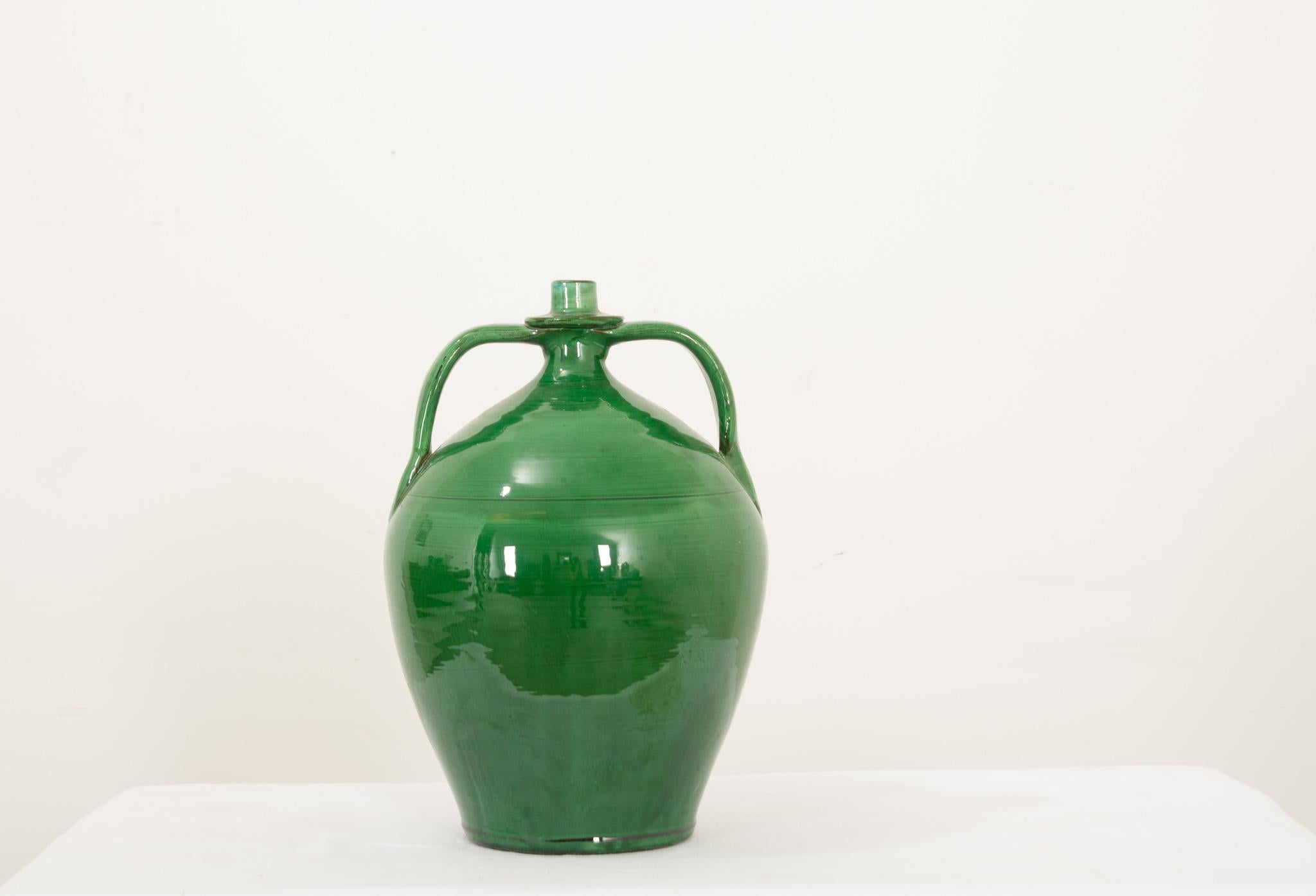 A fantastic mid-century modern, green glazed pottery jar, crafted in Italy by Ceramiche Nicola Fasano. One of the times most sought after ceramicist and one of his most sought after designs. The green glaze is in amazing condition and adds a