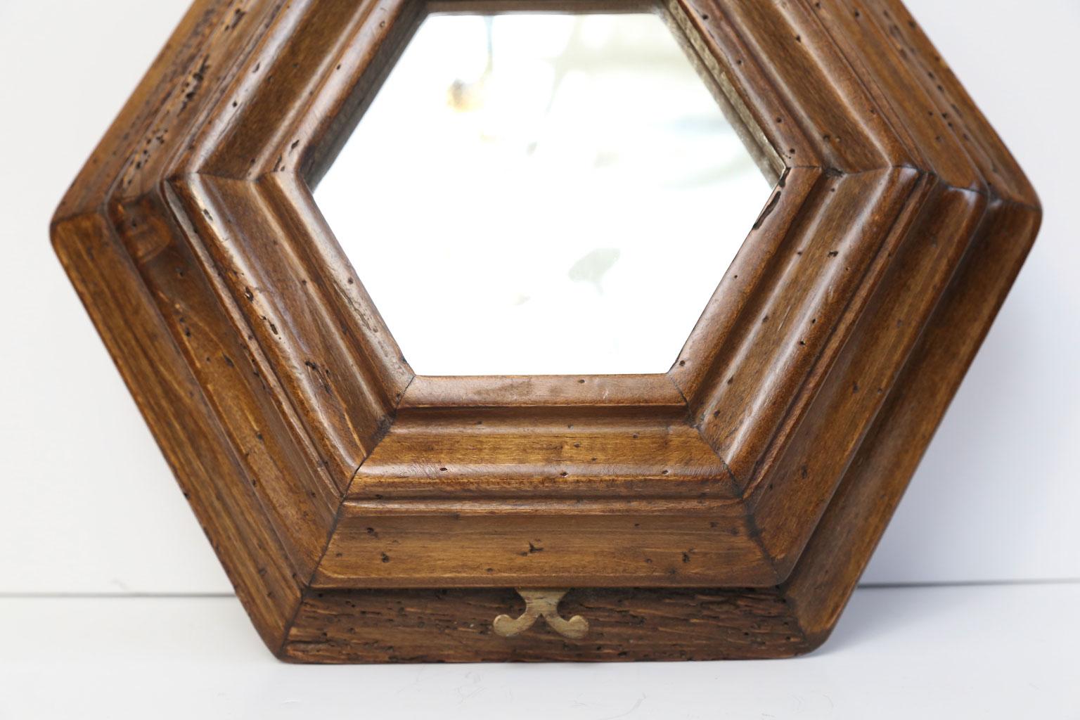 Italian vintage hexagonal mirror in hand carved fruitwood with cast brass lyre-shape hanger. Made circa 1960s - all original. Gorgeous, rich patina.