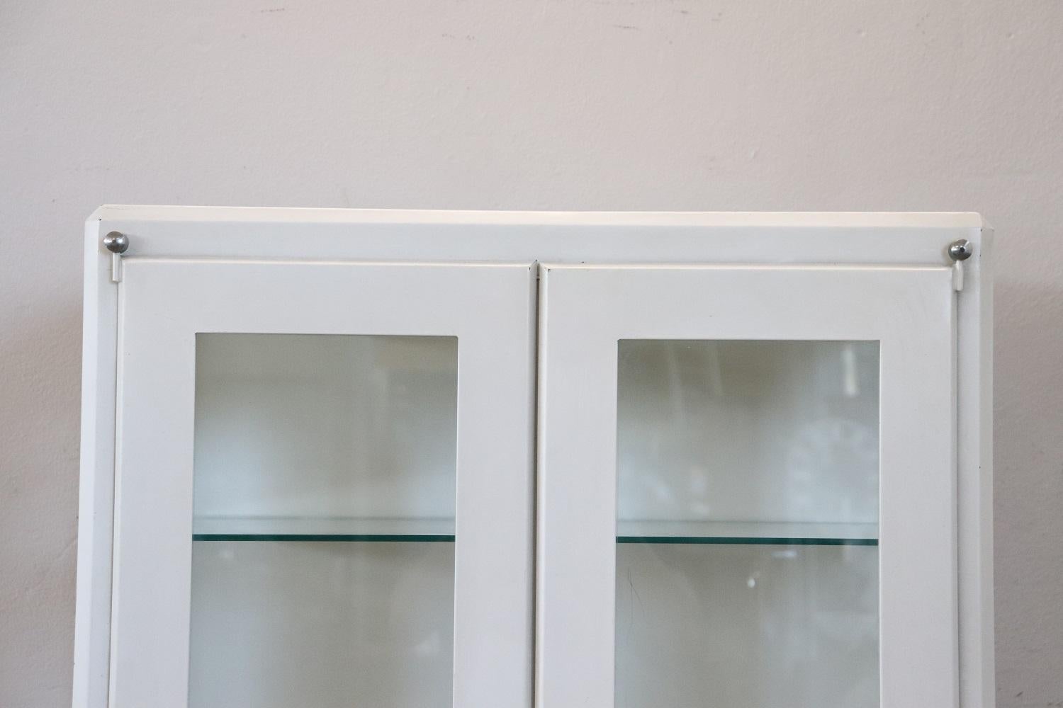 Italian industrial hospital vitrine in white metal, 1960s. Equipped with four glass shelves. This type of display case was used in hospitals or doctors' offices to display medicines. Used conditions.