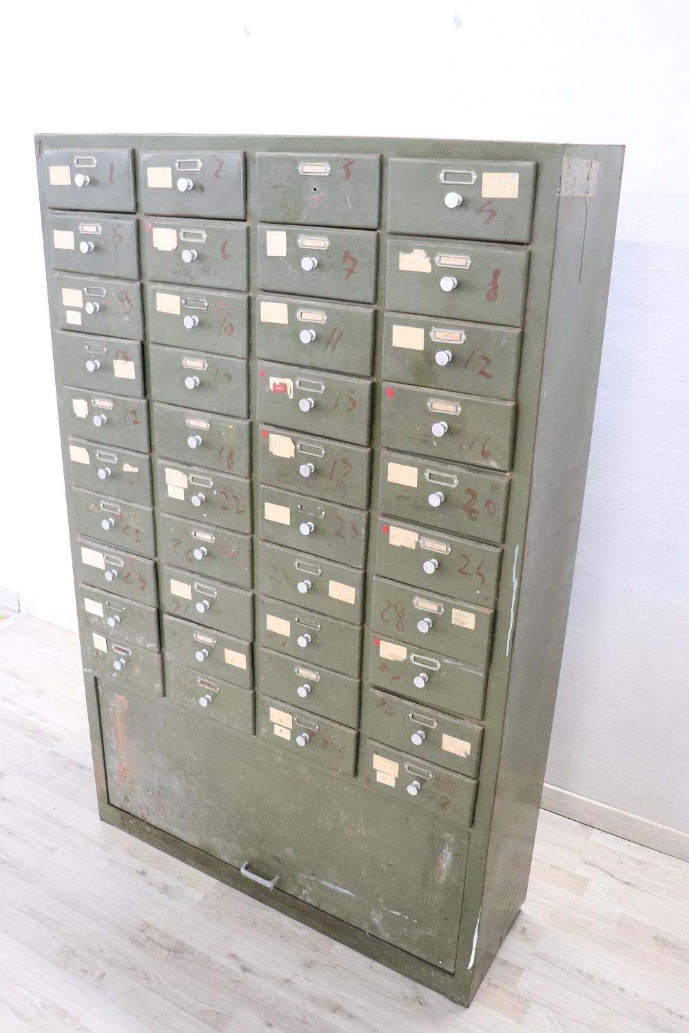 Italian industrial multi drawers metal apothecary cabinet, 1940s. Equipped with forty comfortable drawers. Condition used, one knob is missing.