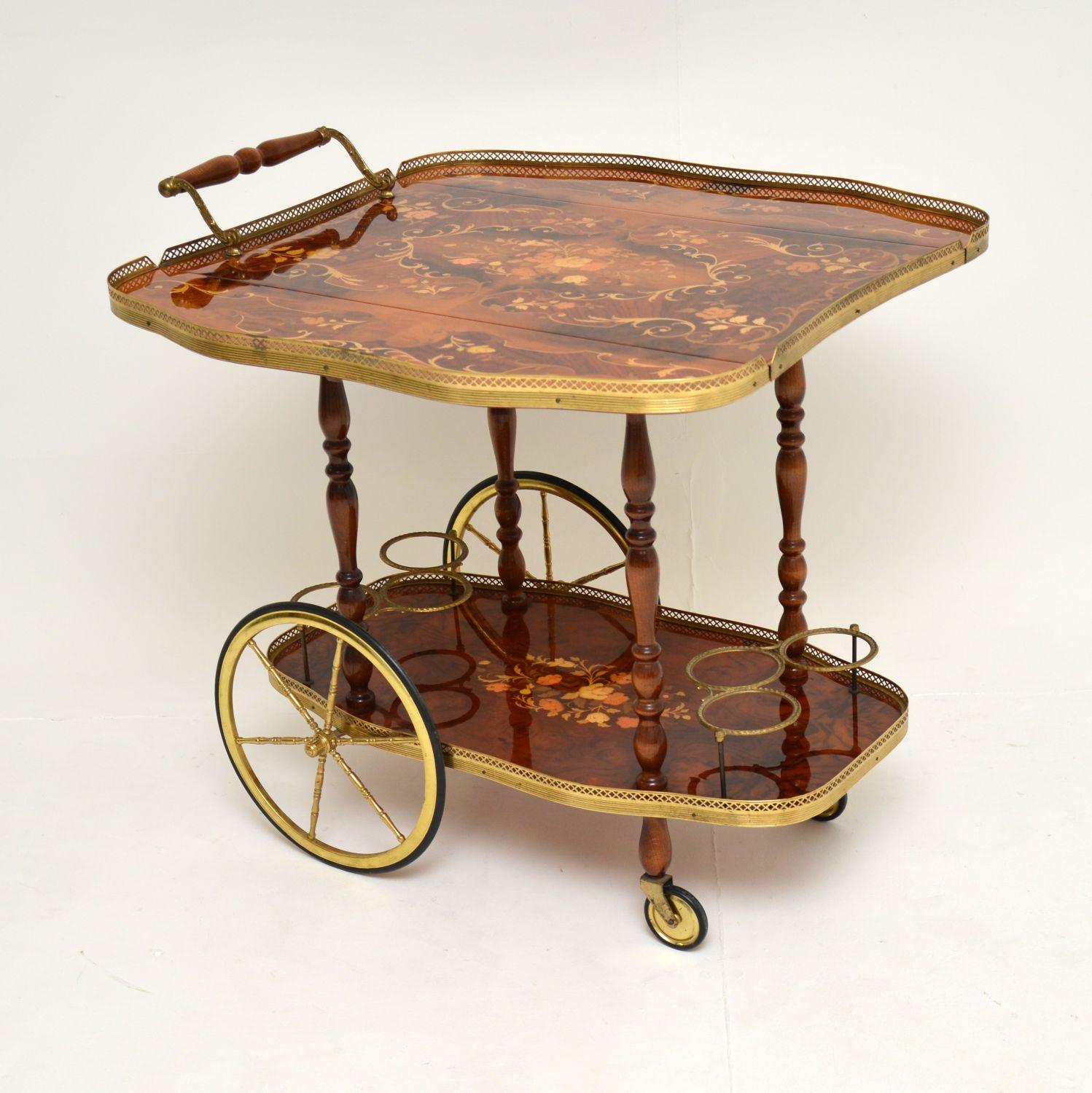 A gorgeous vintage Italian drinks trolley, beautifully made from walnut and brass. This was made in Italy, it dates from the 1950-1960’s.

It is of excellent quality, the top has an unusual drop leaf design and opens out to create a very large