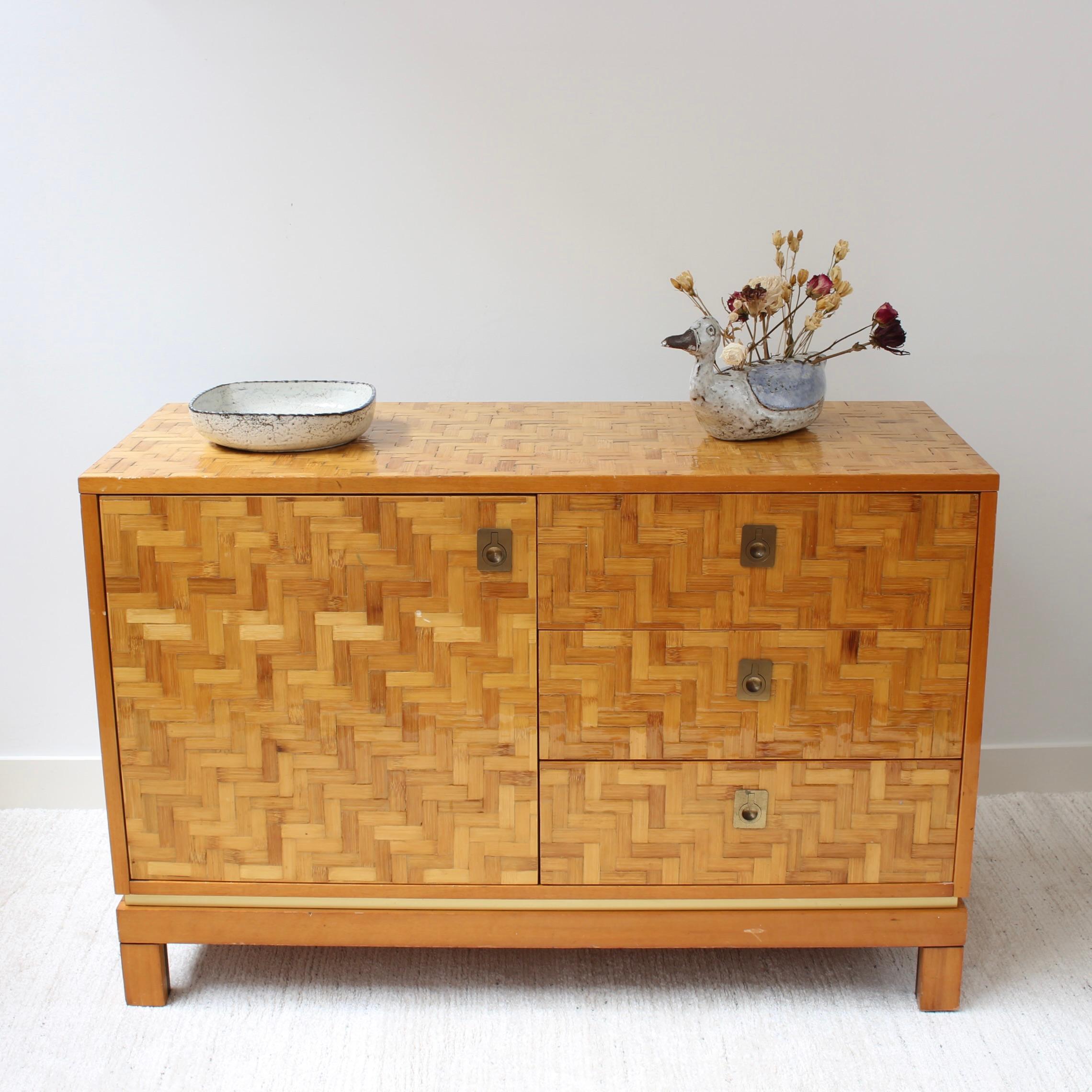 Italian vintage lacquered bamboo marquetry credenza (circa 1970s). Charming piece with three drawers and two shelves of spacious storage surfaces, all with very smart brass exterior fittings. There is some question about the maker - several dealers