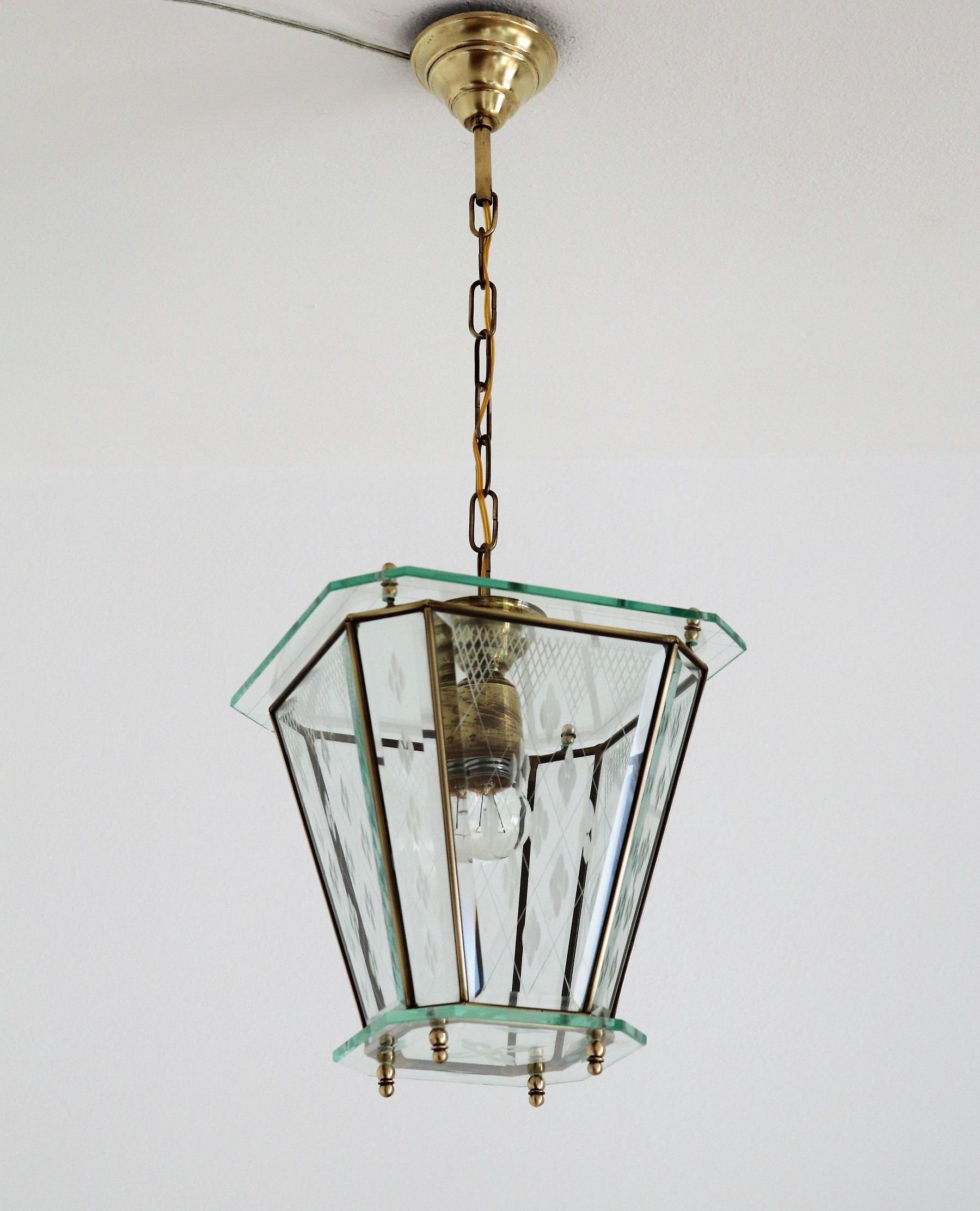Gorgeous pendant lamp or lantern made of beautifully cut glass and brass details.
Made in Italy in the 1950s.
Perfect for a small room, bathroom or an entryway.
The cut glass is much better to see in person and the brass has fantastic patina from