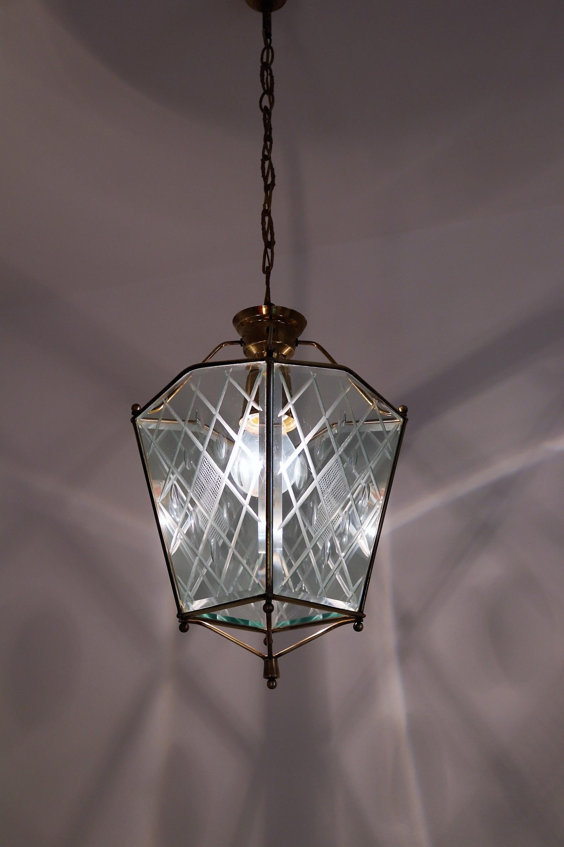Gorgeous pendant lamp or lantern made of beautifully cut glass and brass details.
Made in Italy in the 1950s.
Perfect for a small room, bathroom or an entryway.
The cut glass is much better to see in person and the brass has fantastic patina from
