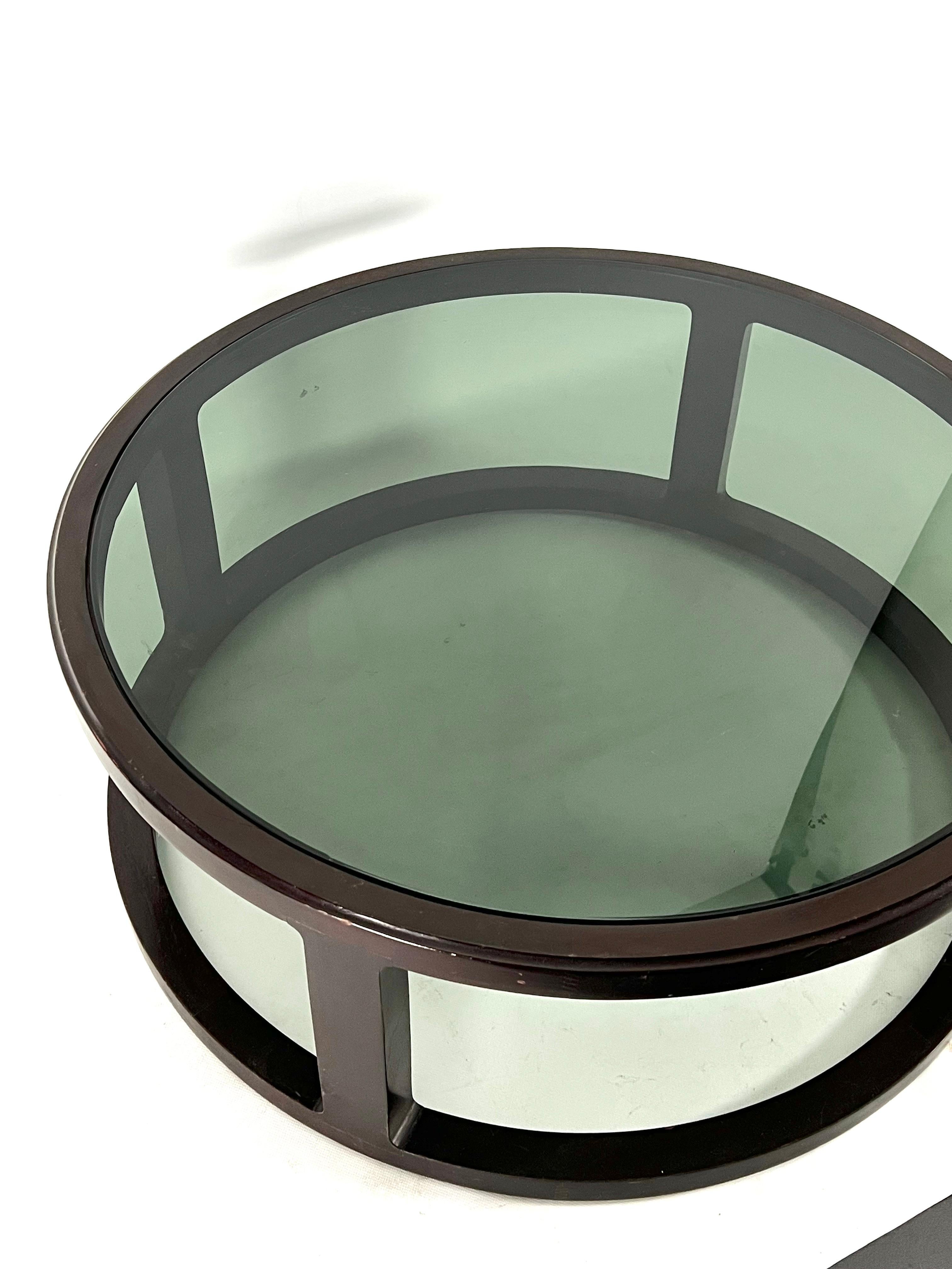 20th Century Italian Vintage Large Round coffee table in wood and fume glass. 1970s For Sale