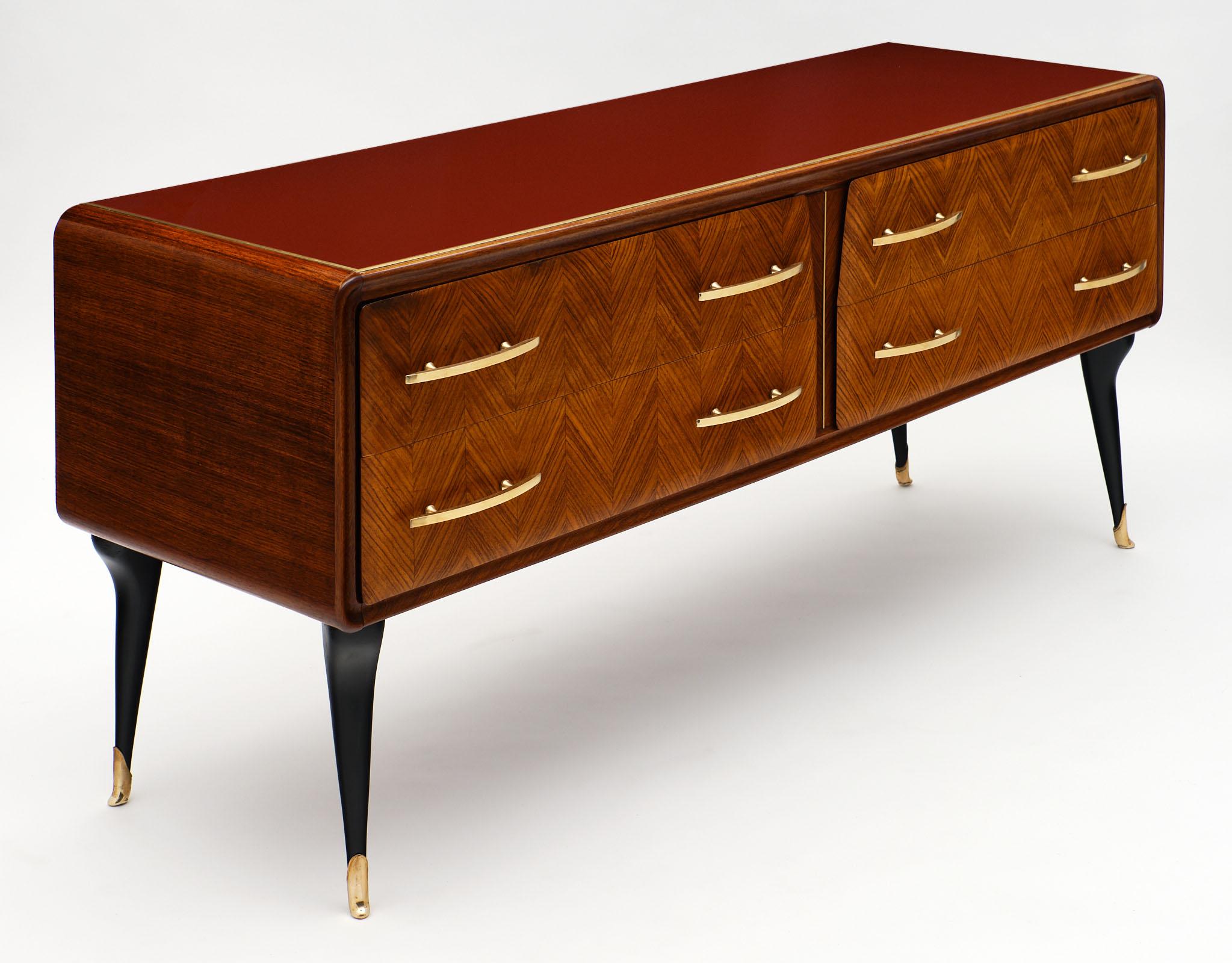 Vintage Italian midcentury chest in the manner of Paolo Buffa and made of Brazilian rosewood. This elegant double chest of drawers features four dovetailed drawers with bronze handles and “chevron” veneer on facade. The cabinet is covered with the