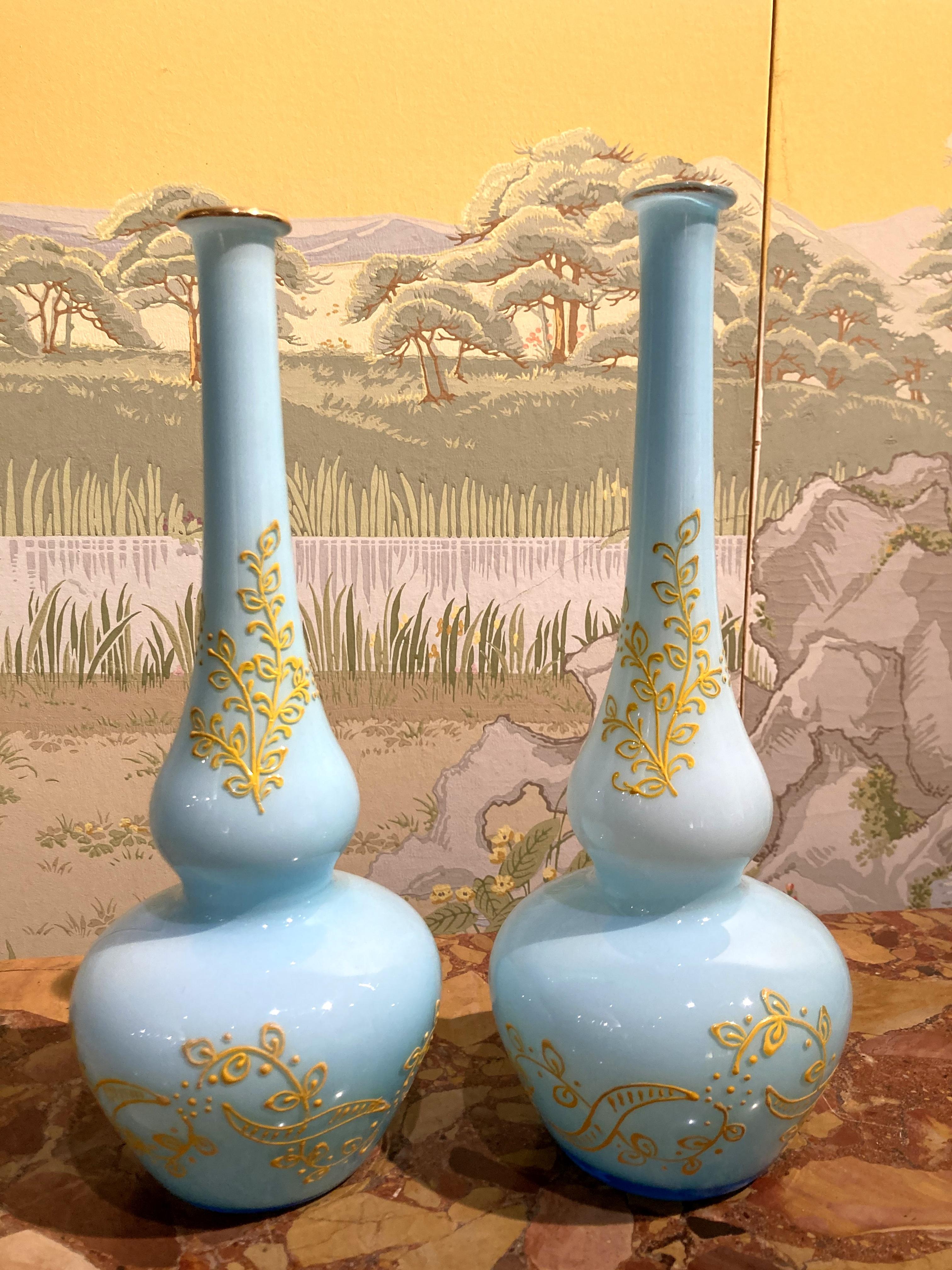 This pair of Italian Mid-Century Modern Murano opaline glass soliflower vases boast a funny trumpet and round belly shape, the most wonderful translucent turquoise color, a lovely yellow hand painted leavy decor and a gilded rim on top. 
The yellow