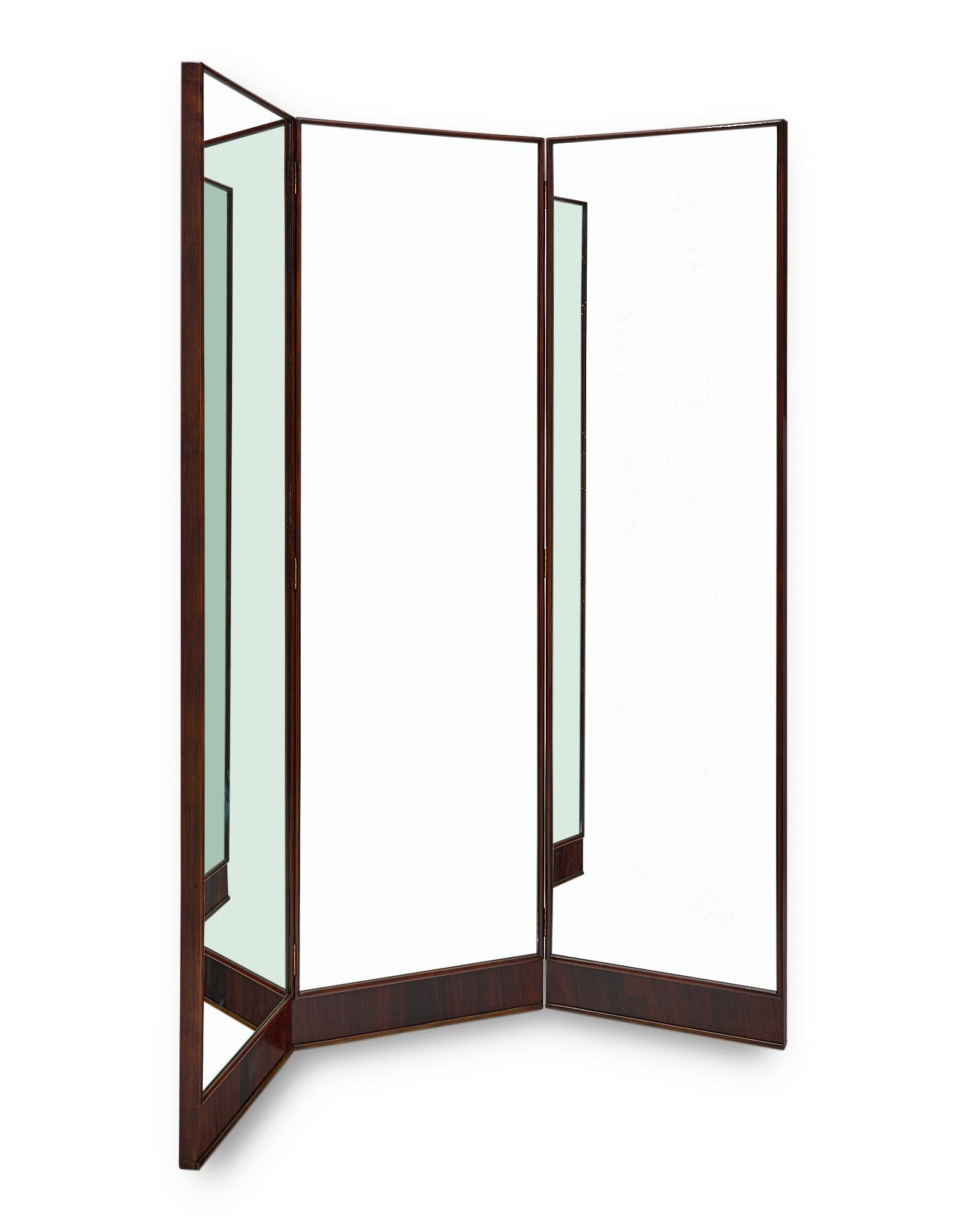 Screen, mirrored, Italian, from the Modernist era. This piece has three mirrors each framed in a solid rosewood structure and hinged together. The central panel is 20.5” in length, while each other panel is 19.25” in length.