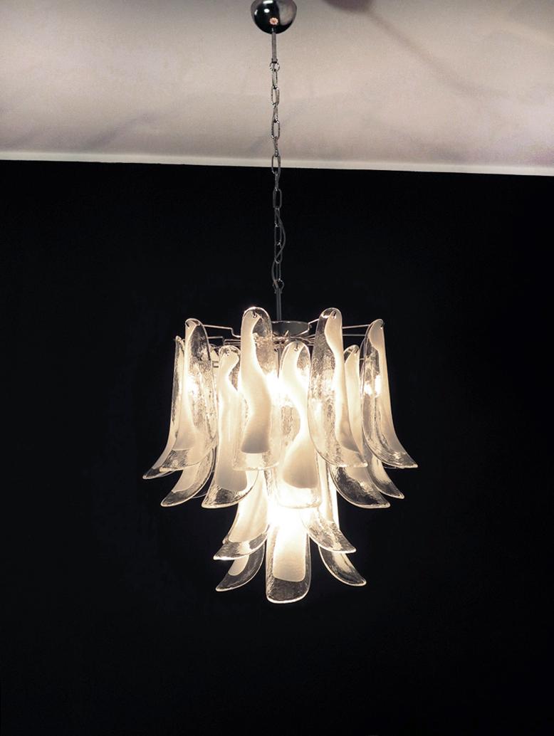 Italian vintage Murano chandelier made by 26 glass petals (trasparent and white “lattimo”) in a chrome frame.
Period: late XX century 
Dimensions: 47,250 inches (120 cm) height with chain; 23,62 inches (60 cm) height without chain; 19,70 inches (50