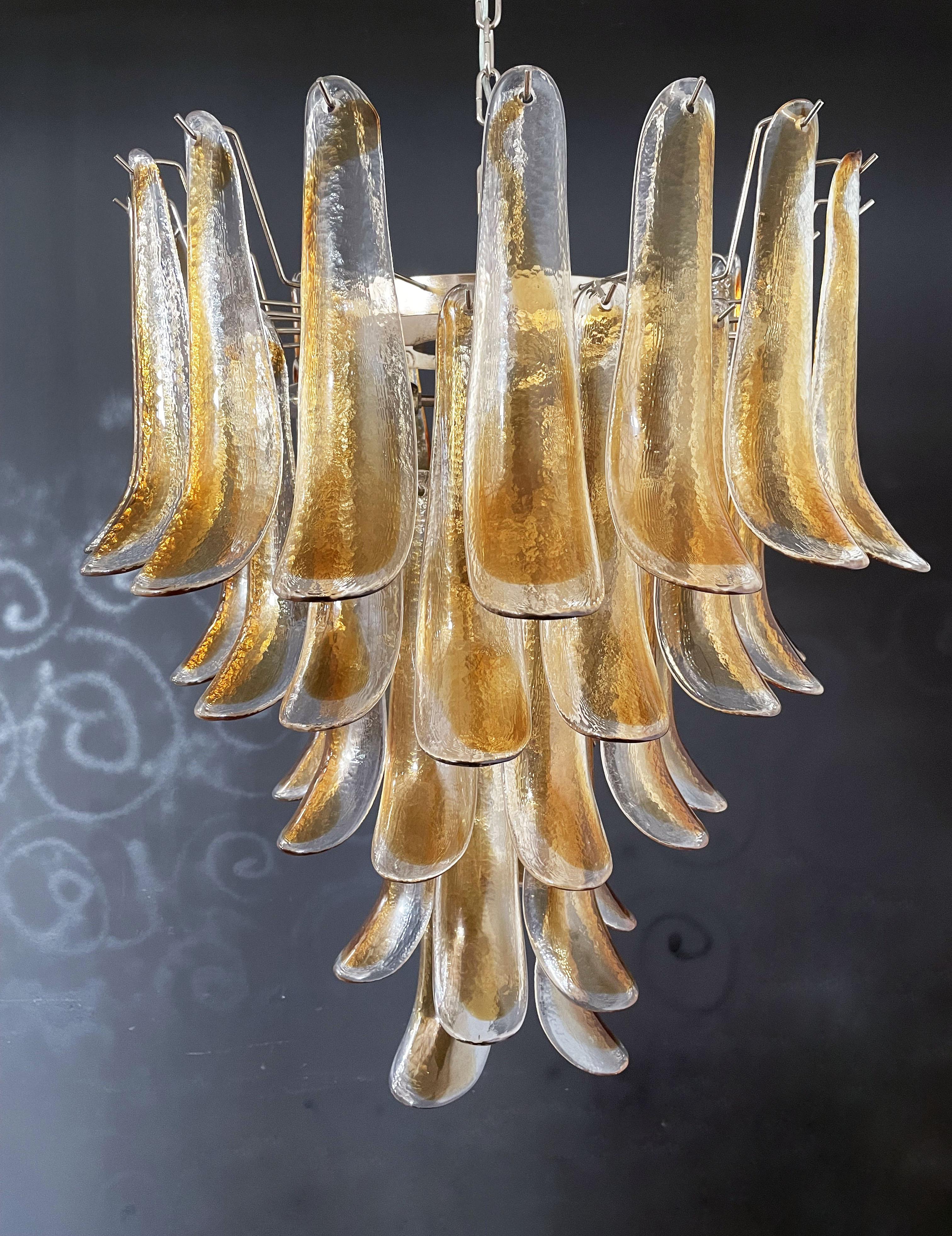 Huge Italian vintage Murano chandelier made by 52 glass petals transparent with an amber spot inside, nickel metal structure. The glasses are very high quality, the photos do not do the beauty, luster of these glasses. in a chrome frame.
Period:
