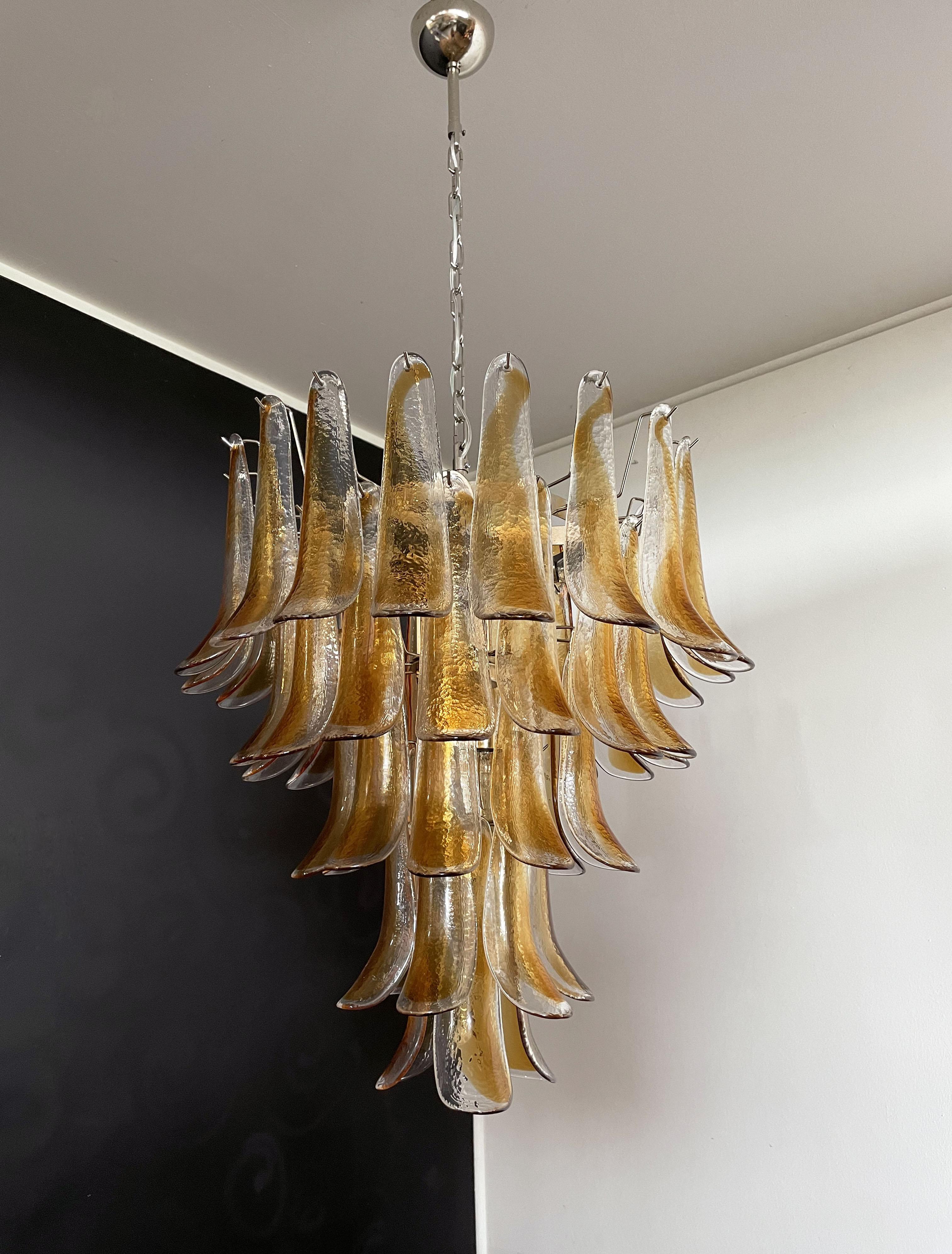 Huge Italian vintage Murano chandelier made by 52 glass petals transparent with an amber spot inside, nickel metal structure. The glasses are very high quality, the photos do not do the beauty, luster of these glasses. in a chrome frame.
Period: