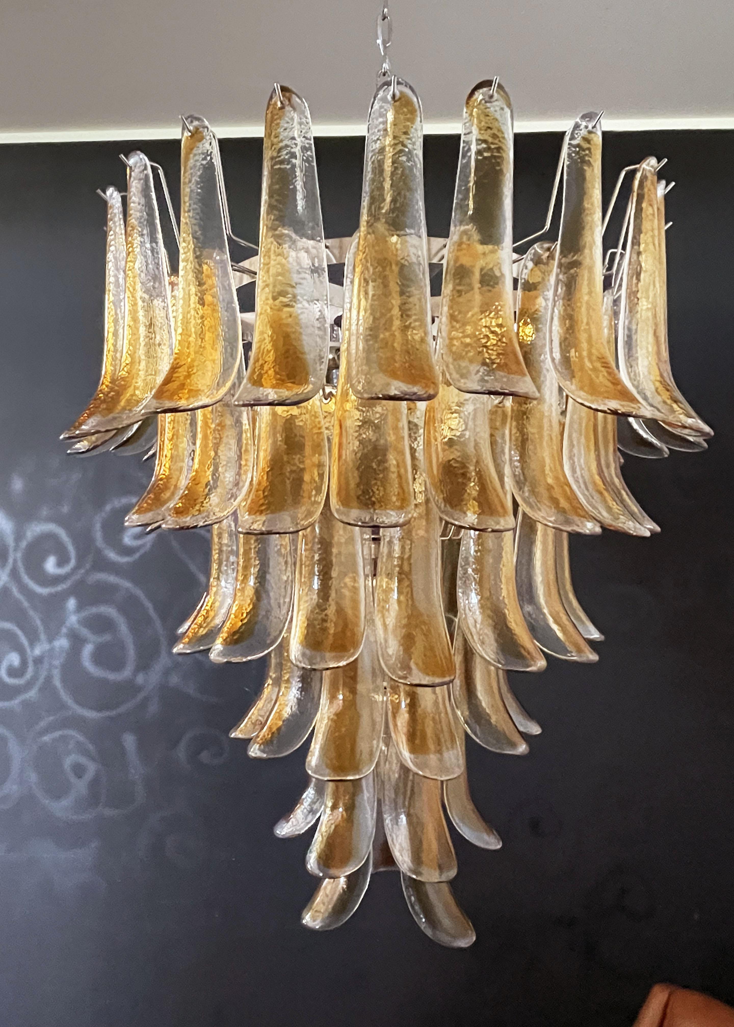 Huge Italian vintage Murano chandelier made by 75 glass petals transparent with an amber spot inside, nickel metal structure. The glasses are very high quality, the photos do not do the beauty, luster of these glasses.
Period: late XX