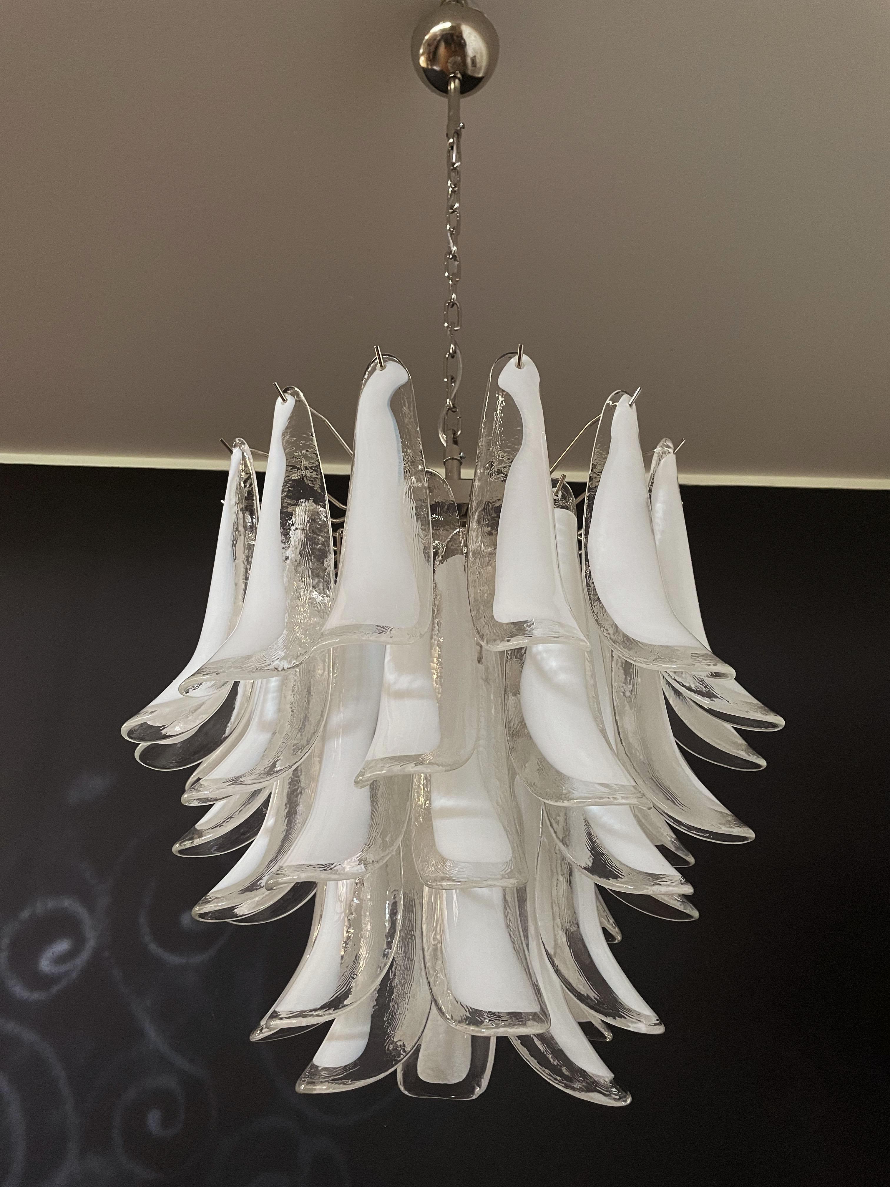 Huge Italian vintage Murano chandelier made by 41 glass petals (transparent and white “lattimo”) in a chrome frame.
Period: Late XX century 
Dimensions: 46 inches (117 cm) height with chain; 25,60 inches (65 cm) height without chain; 22,85 inches