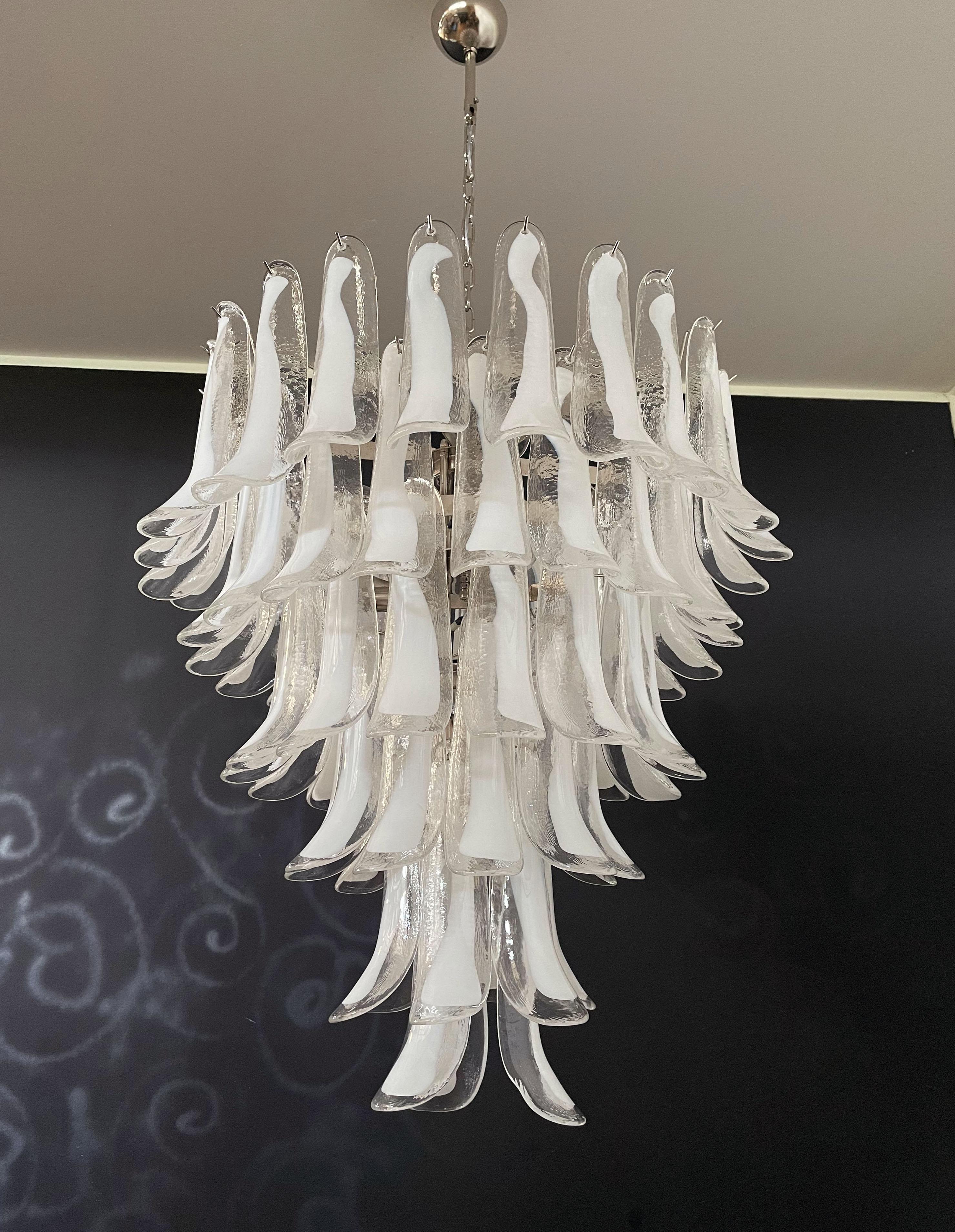 Huge Italian vintage Murano chandelier made by 75 glass petals (transparent and white “lattimo”) in a chrome frame.
Period: late XX century
Dimensions: 65 inches (165 cm) height with chain; 37,40 inches (95 cm) height without chain; 31,50 inches (80