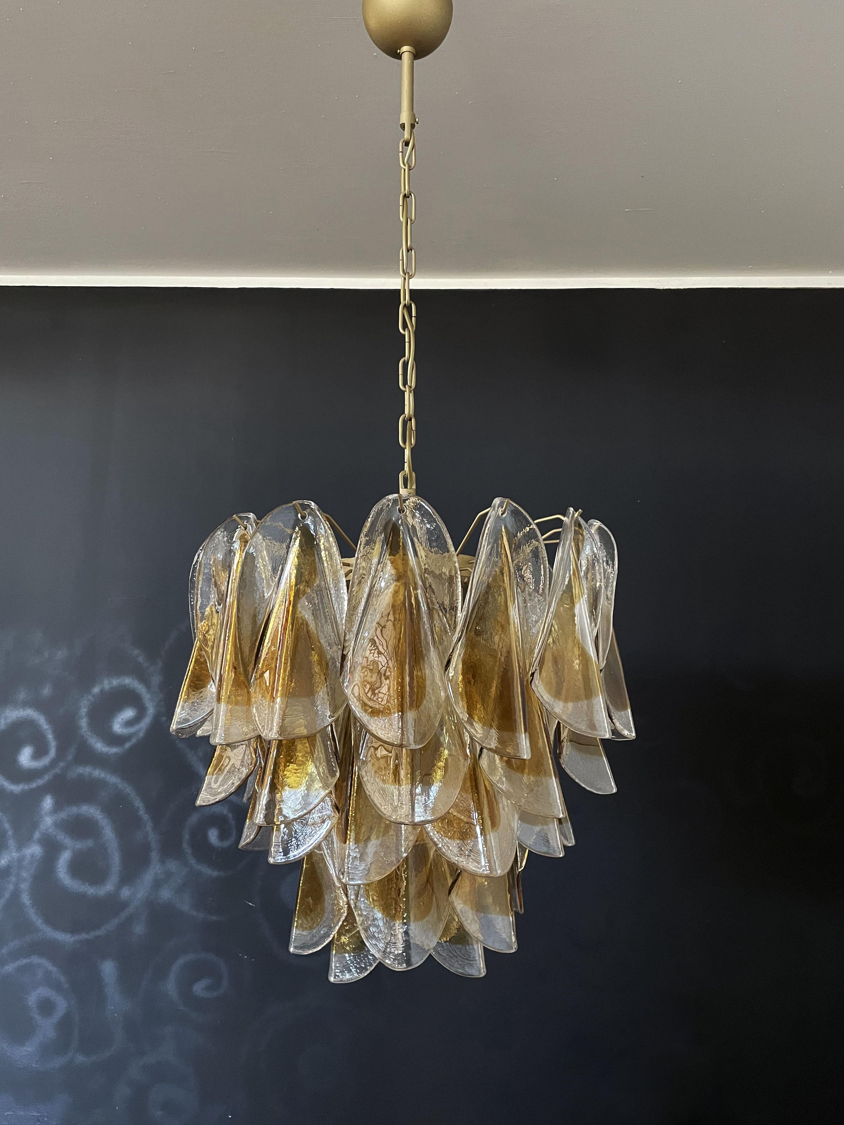 Rare Italian vintage Murano chandelier. The fixture is made up of 41 individual handblown glass elements hanging (transparent and amber) from a gold painted metal frame. Each piece clear with amber centre.
Period: late XX century
Dimensions: 47,25
