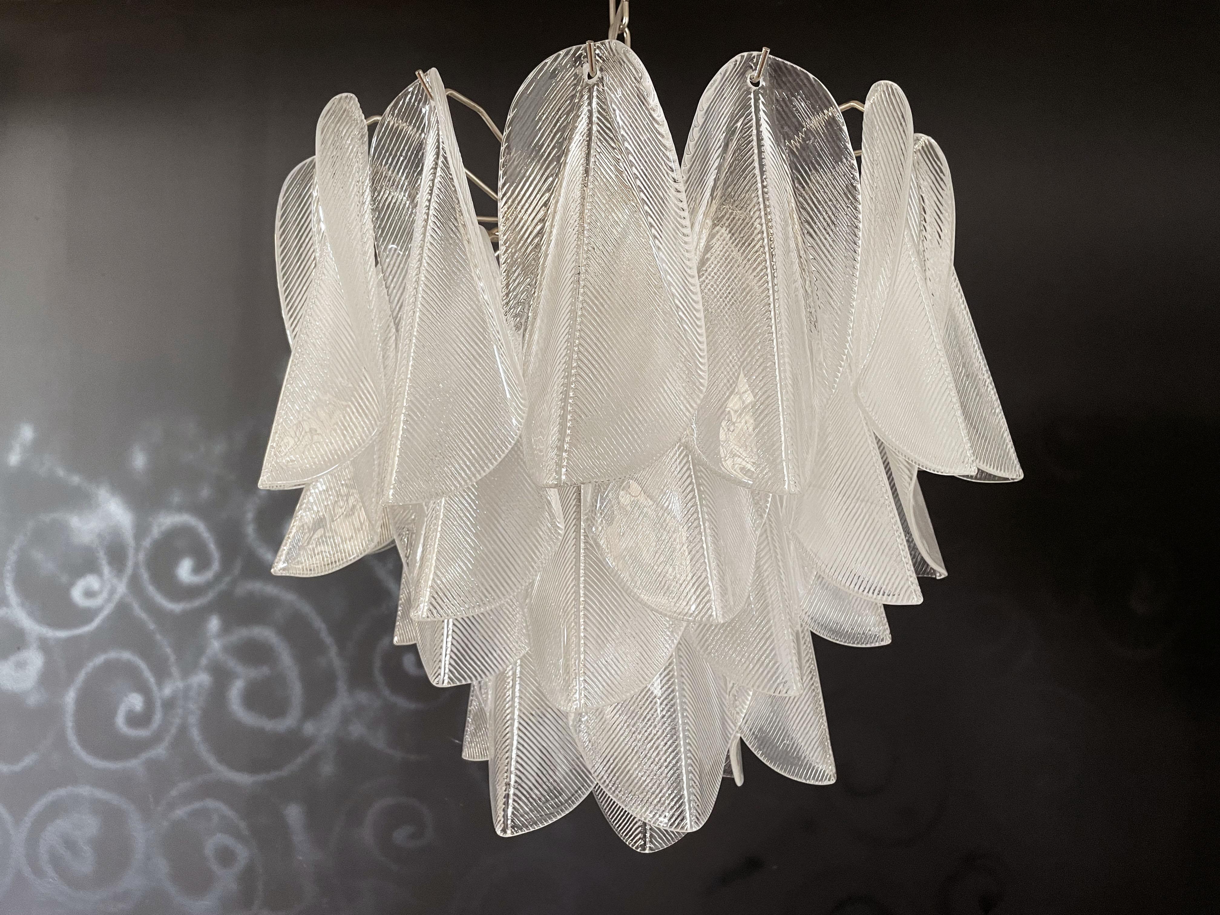 
Rare Italian vintage Murano chandelier. The fixture is made up of 41 individual handblown transparent glass elements hanging from a chrome frame.
Period: 1980's
Dimensions: 49,20 inches (125 cm) height with chain; 21,65 inches (55 cm) height