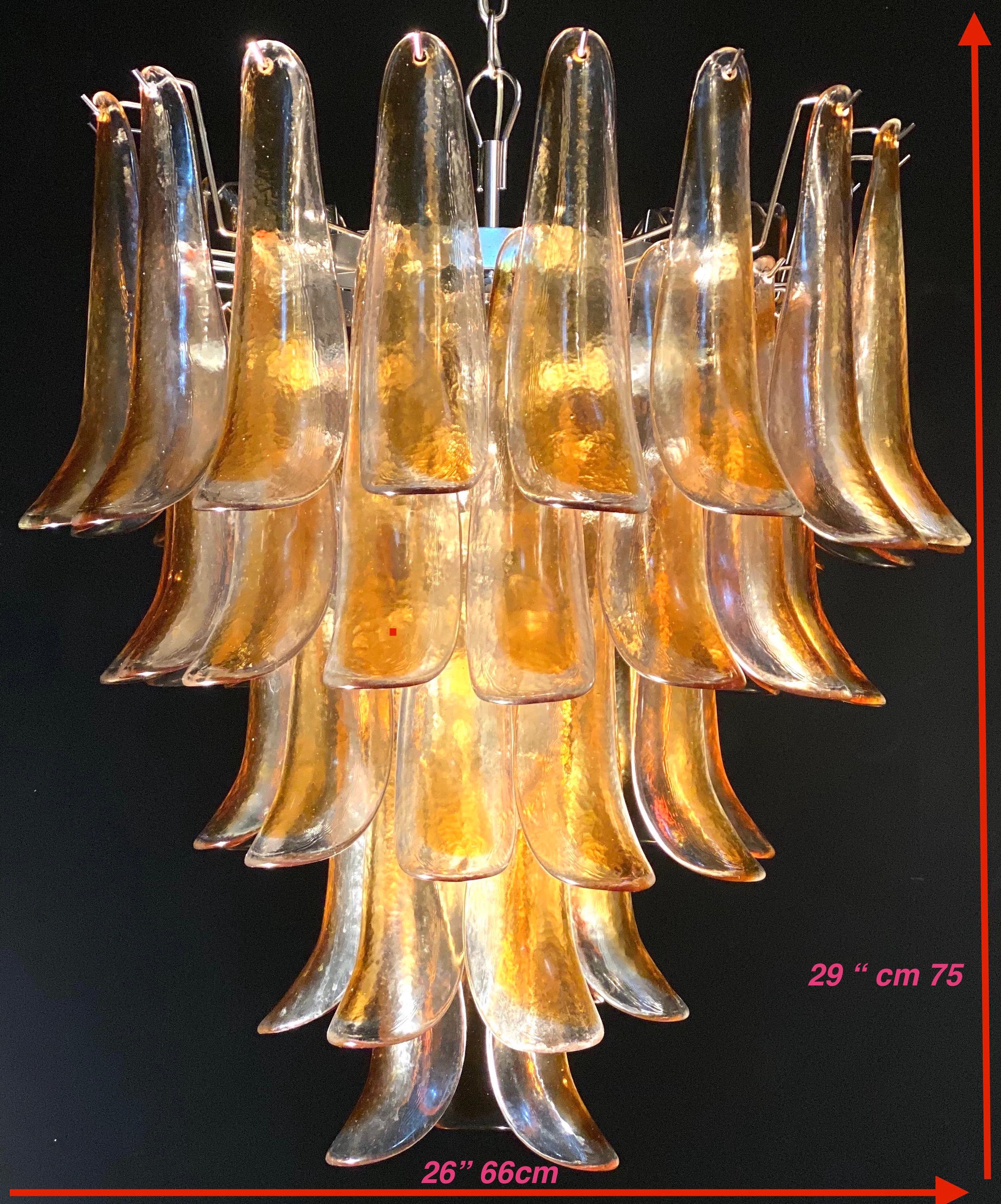 Italian vintage Murano chandelier made by 52 clear amber glass petals supported by a chrome frame.
The clear amber color of the glasses create a fabulous warm light effect.
Period: 1970s
Price is for 1 item 
Dimensions: 55.10 inches (140 cm) height