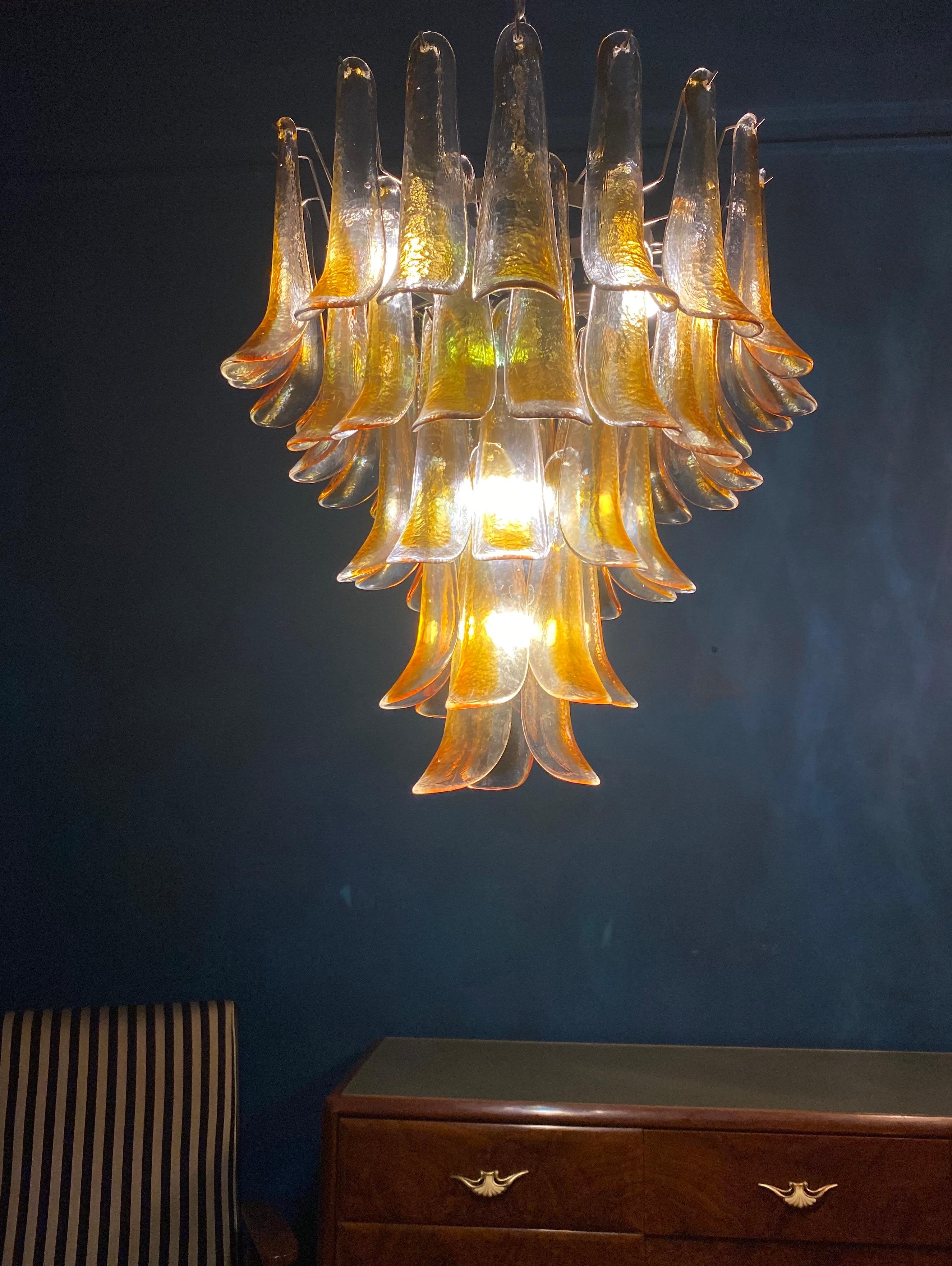 Italian vintage Murano chandelier made by 52 clear amber glass petals supported by a chrome frame.
The clear amber color of the glasses create a fabulous warm light effect.
Period: 1970s
Dimensions: 55.10 inches (140 cm) height with chain; 29.50