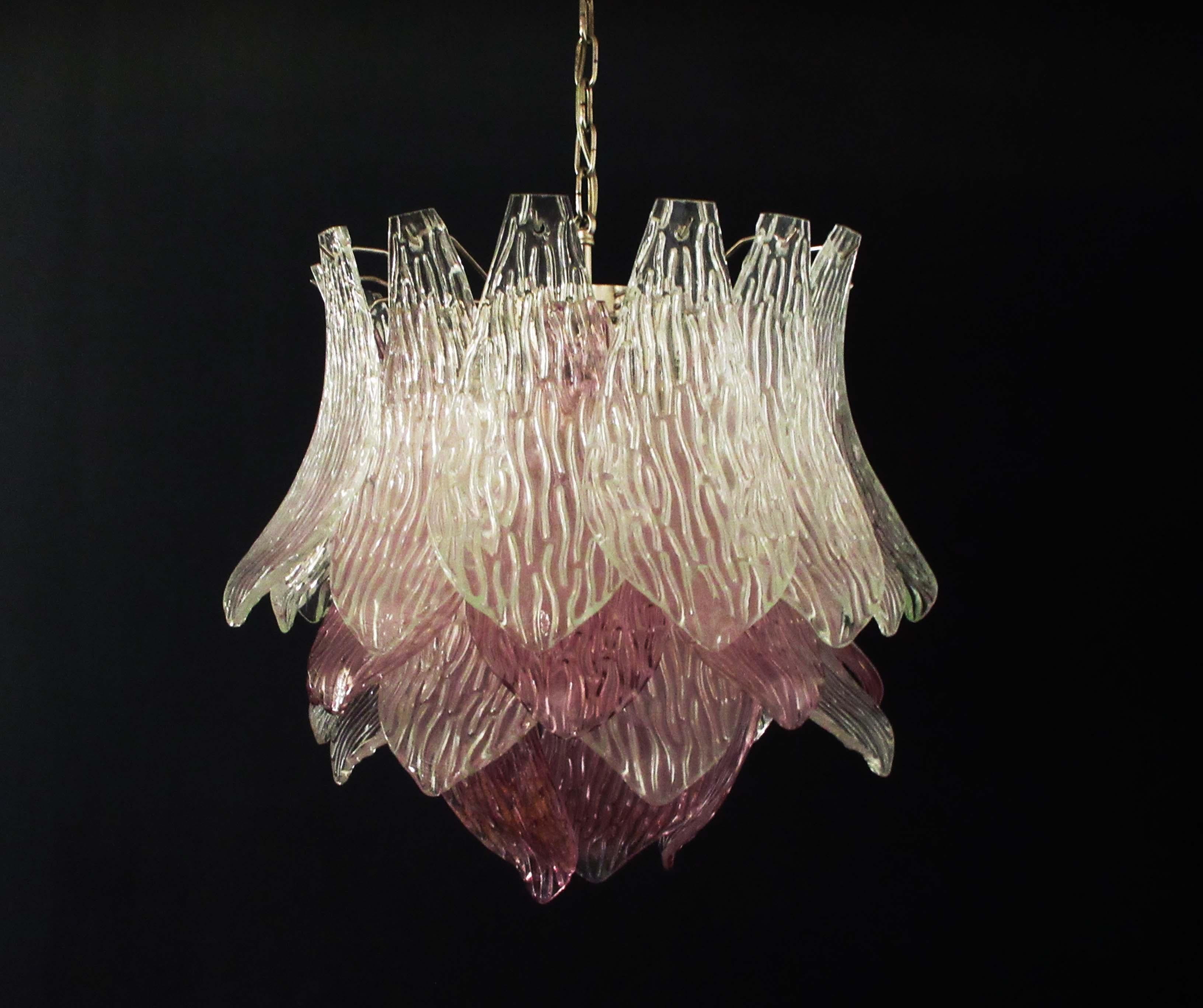 Beautiful and huge Italian Murano chandelier composed of 38 splendid transparent and amethyst glasses that give a very elegant look. The glasses of this chandelier are real works of art. This chandelier is shaped like a blossoming flower.
Period: