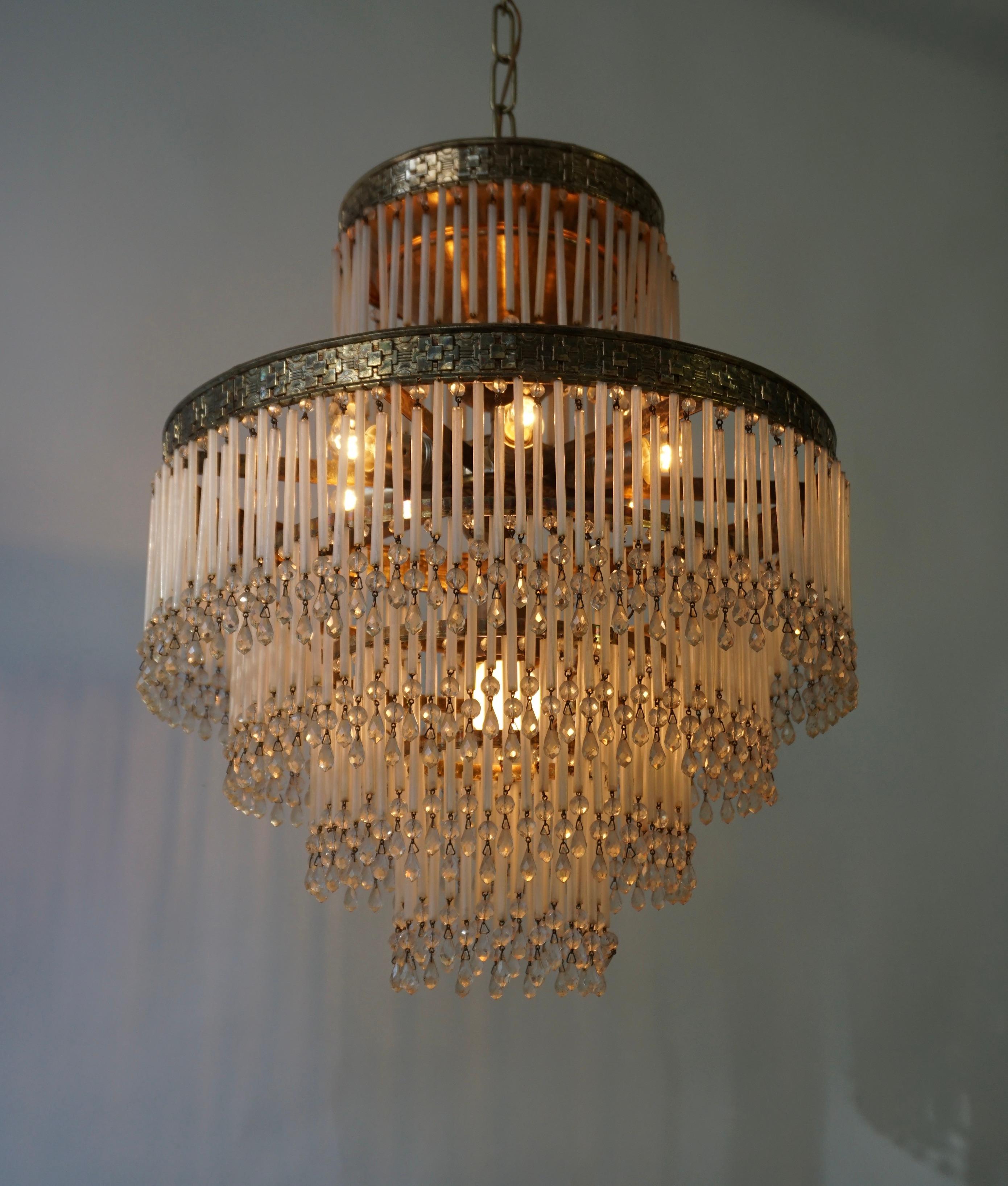 Beautiful Italian opalescent Hollywood vintage regency hanging lamp with rods and transparent crystal beads.

Fantastic effect due to the multiple layers of glass rods. The frame has a special motif that beautifully reflects the time in which this
