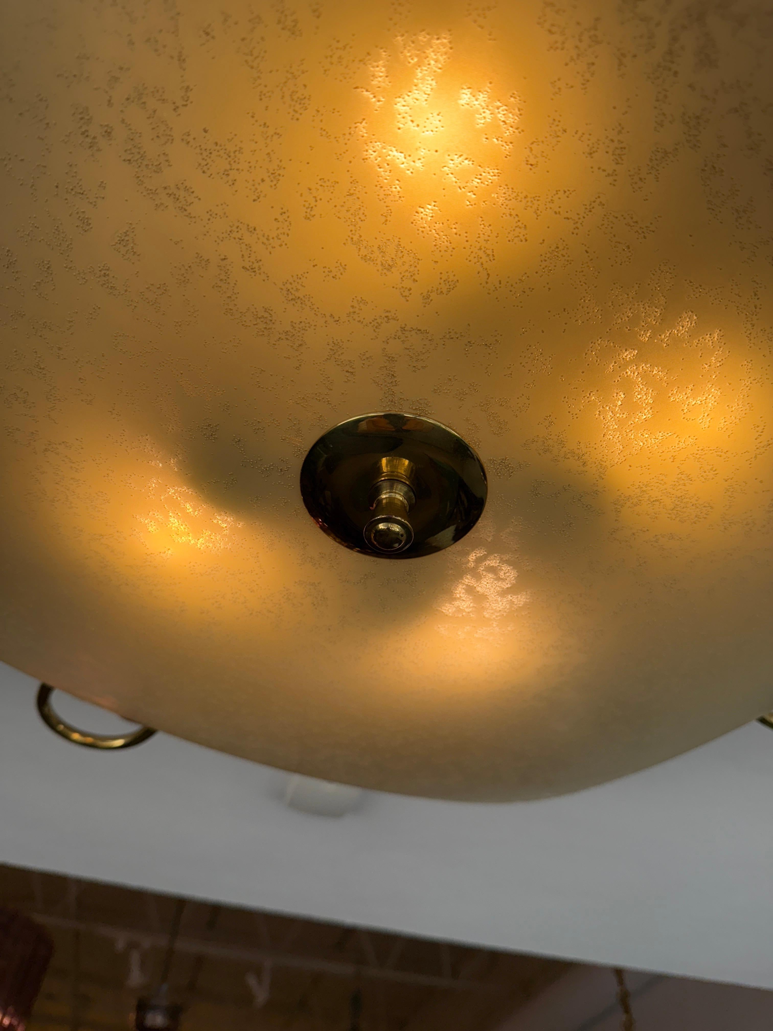 This lovely classic Italian design plafonnier/ flush mount light with a large opaque/frosted glass diffuser and brass tubular accents.  Provides a warm diffused light which is perfect for many spots in your home.