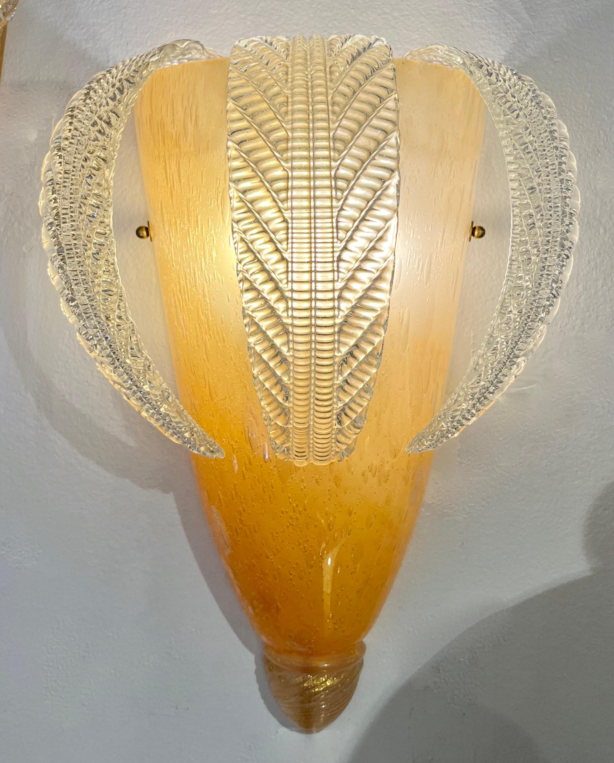 Vintage sculptural Venetian organic wall lights with hanging crystal leaves. The central cone shape core in high-quality Venetian Murano glass in a very chic golden amber color worked with the Pulegoso technique: lots of irregular air bubbles, the