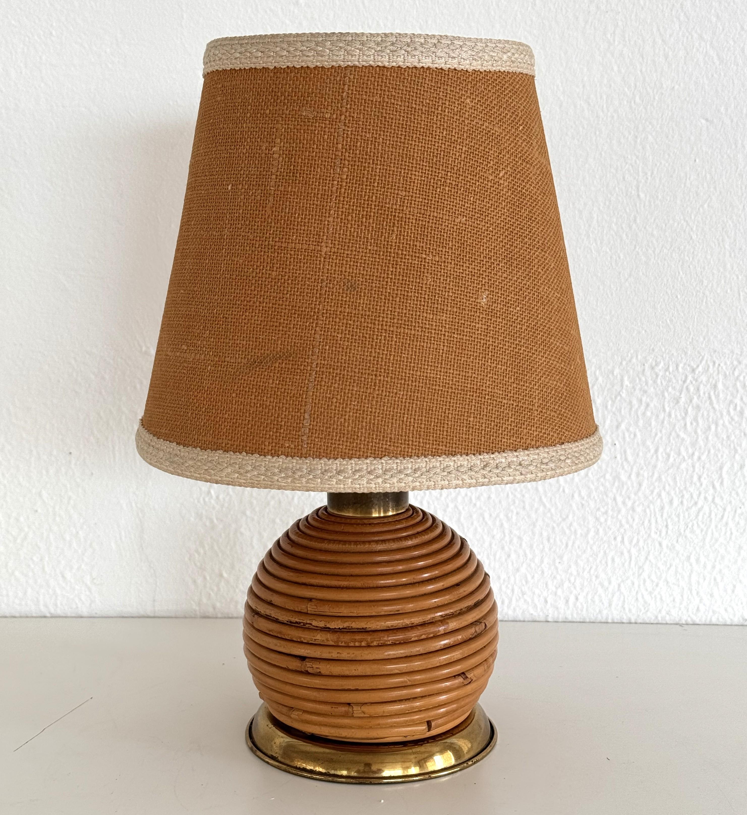 Italian Vintage Rattan Boho Table Lamp with Metal Base, 1970s

Very nice organic table lamp made of rattan - bamboo with brass details, Boho style, by Vivai del Sud.
With original lampshade.
The spherical lamp is in very good vintage condition. 
It