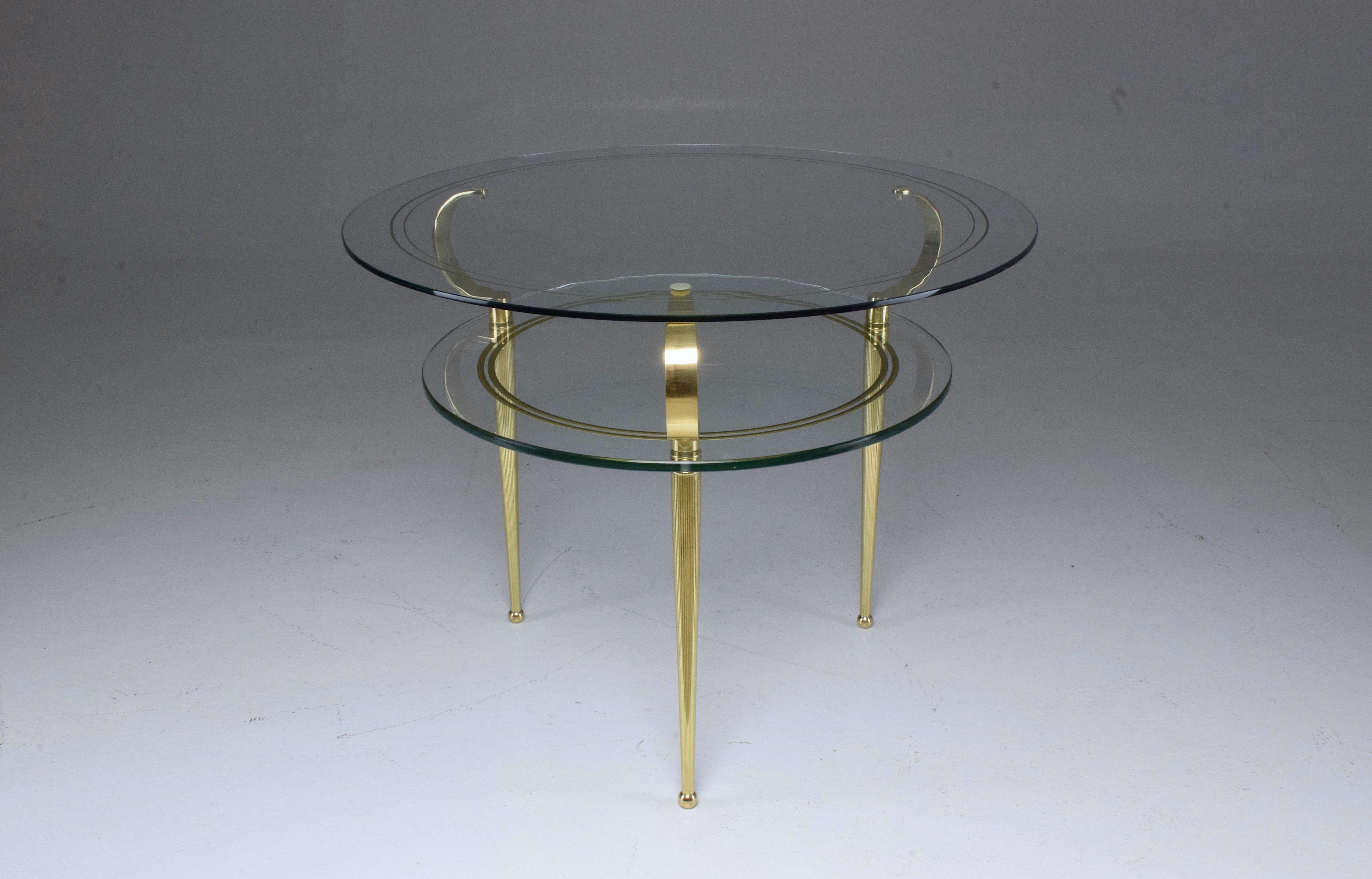 A 20th century vintage circular coffee or side table designed by Italian master Cesare Lacca, circa 1950s, composed of a two-tiered glass tabletop with gold leaf decorative engraved trims. The structure is made out of an astonishing curved gold