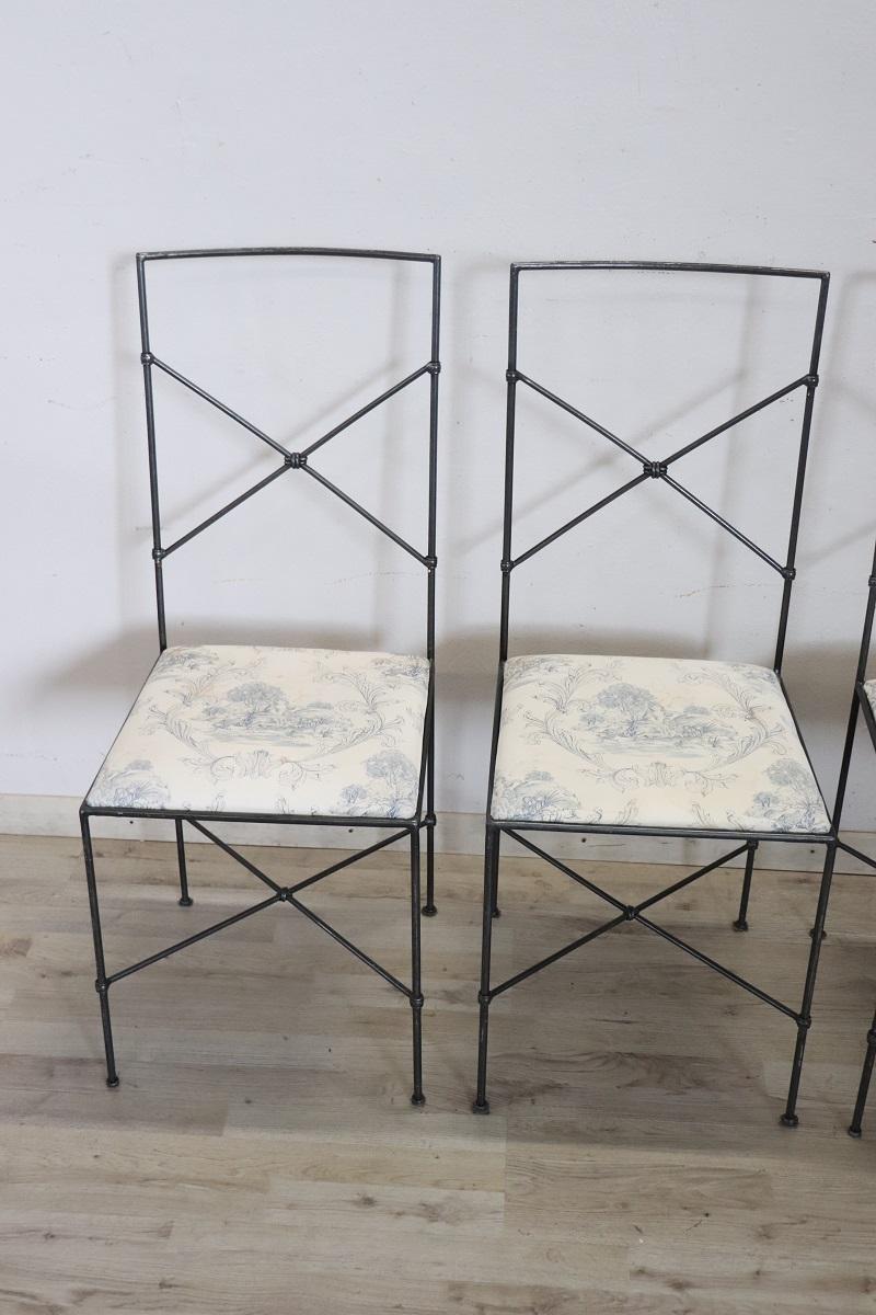 Italian vintage lovely set of four dining room chairs, 1980s. The structure is in iron black lacquered. The seat is padded and comfortable. Very simple and linear, they convey great lightness. Perfect to be combined with a modern table, for example