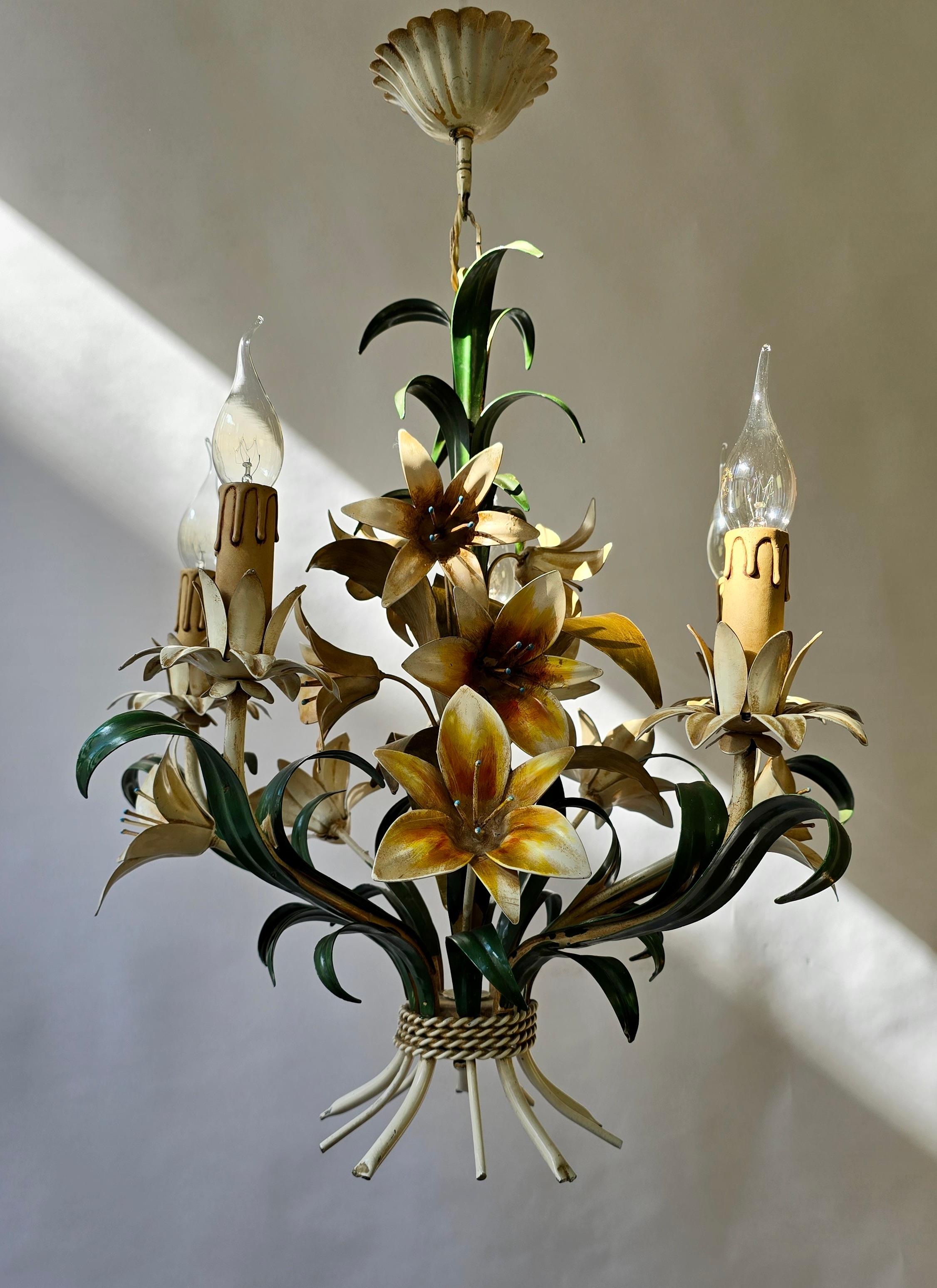 Italian Vintage Tole Floral Chandelier, circa 1950s

A stunning hand-painted Italian tole chandelier, crafted in the mid-20th century with exquisite attention to detail. This elegant fixture features beautifully sculpted lilies in soft tones of