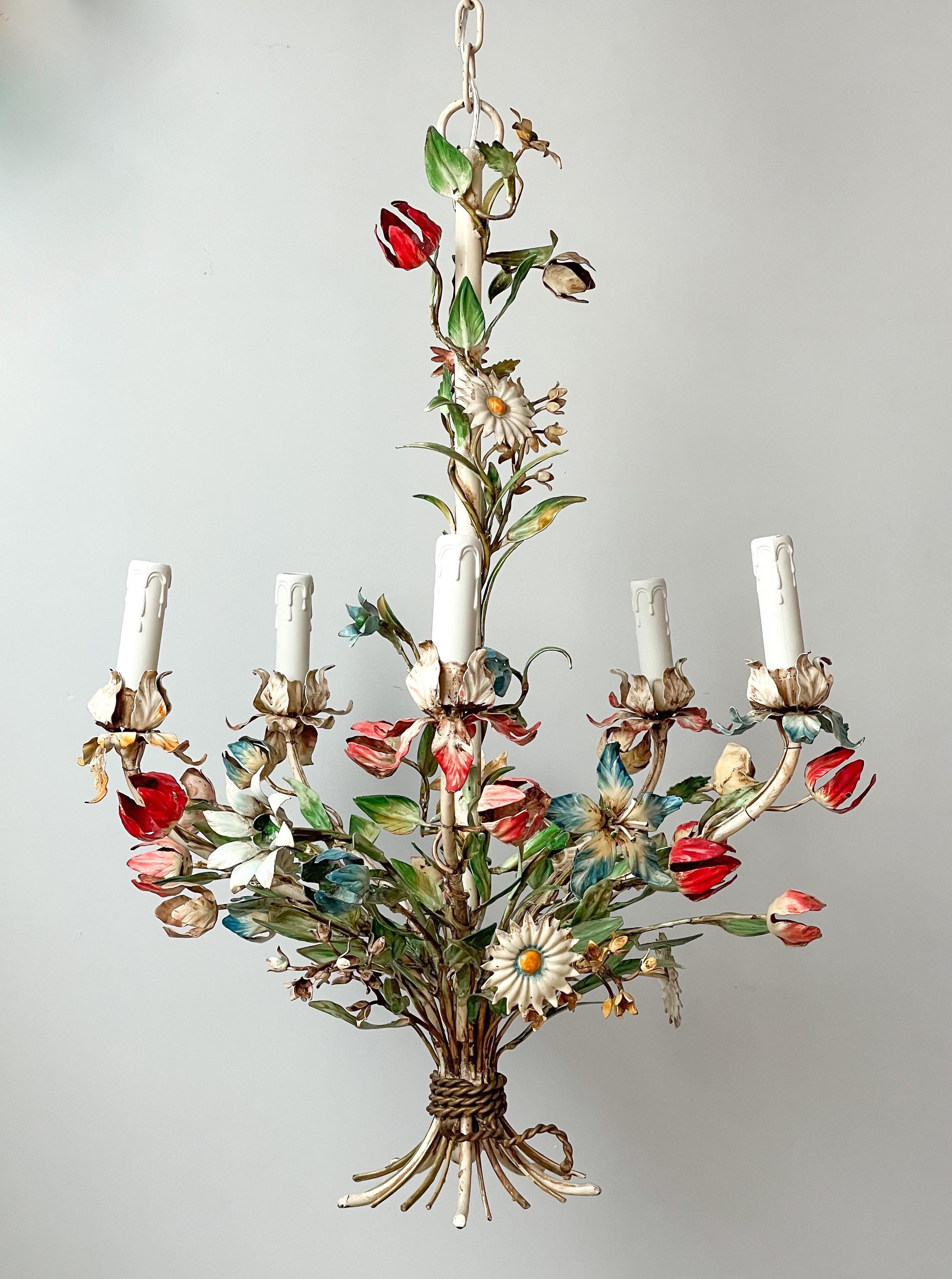 Exquisite, Italian 1940s painted iron chandelier depicting a bouquet of wild flowers. 

The chandelier consists of an intricately made iron frame in the shape of a bouquet of flowers in a variety of colors being held together by an iron “rope”