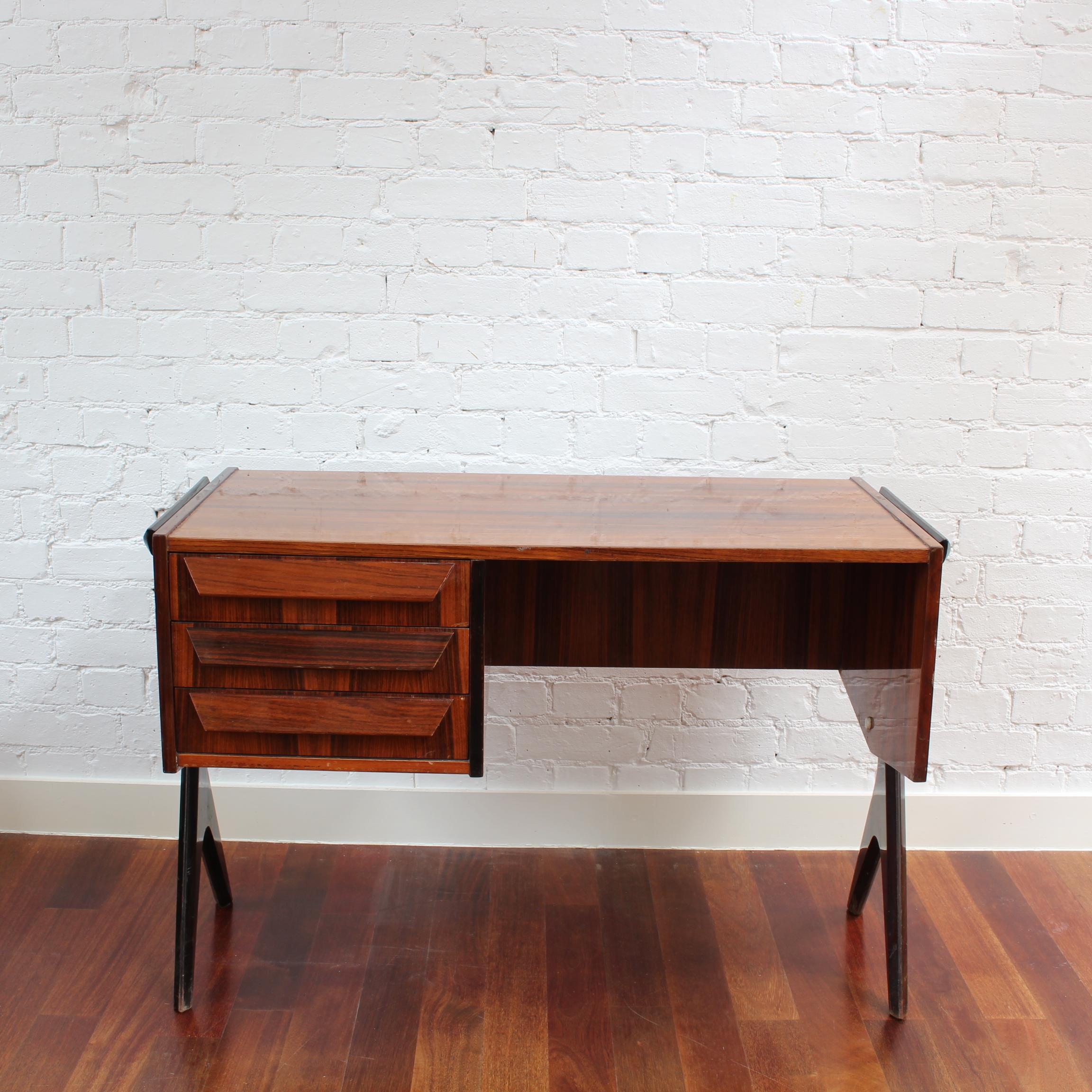 Italian vintage writing desk attributed to celebrated furniture maker, Vittorio Dassi (circa 1950s). This represents iconic design along with a gorgeous marquetry exterior and iconic boomerang-shaped legs which are trademarks of Dassi's furniture.